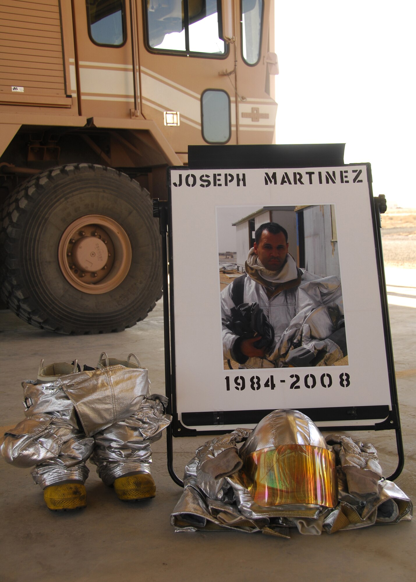 SOUTHWEST ASIA -- A photo of firefighter Senior Airman Joseph Martinez, who was killed in a non-combat related injury on Nov. 29, on display during a memorial service at an air base in Southwest Asia. The firefighters deployed to the 386th Expeditionary Civil Engineer Squadron held a memorial service for Airman Martinez, a firefighter from the 156th Airlift Wing, Puerto Rico Air National Guard, who was killed in a non-combated related injury. He was deployed to the 386th Expeditionary Civil Engineer Squadron from April through September 2008. (U.S. Air Force photo/Tech. Sgt. Raheem Moore)