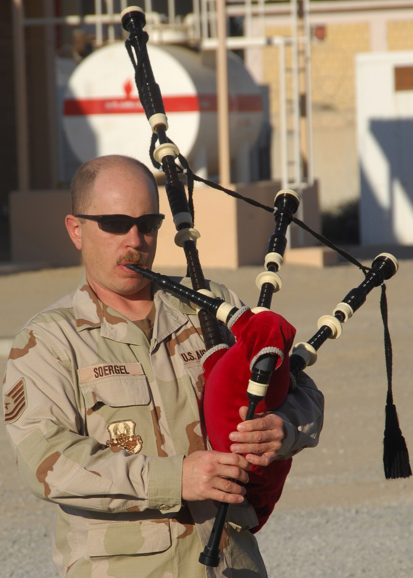 SOUTHWEST ASIA -- Tech. Sgt. Peter Soergel plays the bagpipe during the memorial service for fallen firefighter Senior Airman Joseph Martinez on Dec. 8 at an air base in Southwest Asia. Airman Martinez was a firefighter from the 156th Airlift Wing, Puerto Rico Air National Guard, and was deployed to the 386th Expeditionary Civil Engineer Squadron from April through September 2008. (U.S. Air Force photo/Tech. Sgt. Raheem Moore) 