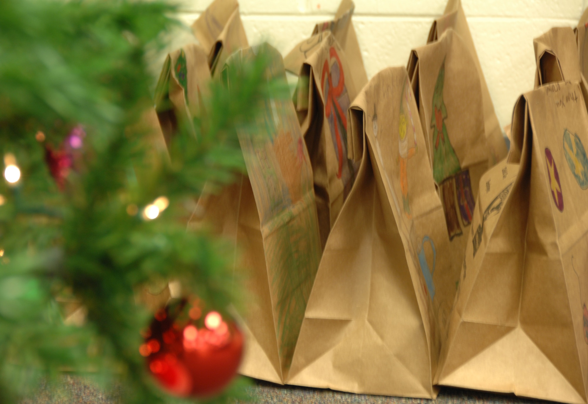 SHAW AIR FORCE BASE, S.C. -- Each brown paper bag and Christmas card used for the Annual Cookie Drive features unique artwork by children from local schools and churches. The bags are shipped overseas to Team Shaw's deployed servicemembers and distributed to Airmen who live in the dorms on base. (U.S. Air Force photo/2nd Lt. Emily Chilson)