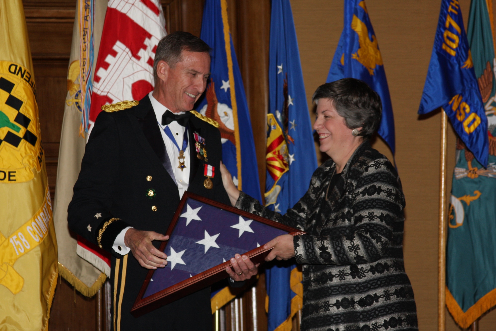 SCOTTSDALE, Ariz. - Maj. Gen. David P. Rataczak, the Adjutant General of Arizona, is presented with a flag that was flown over the 161st Air Refueling Wing by Governor Janet Napolitano during a ceremony honoring Rataczak's retirement and 43 years of military service. More than 400 people attended the gala event that was held at the Scottsdale Resort and Conference Center Dec. 6.  (Army National Guard photo by Sgt. Ed Balaban)