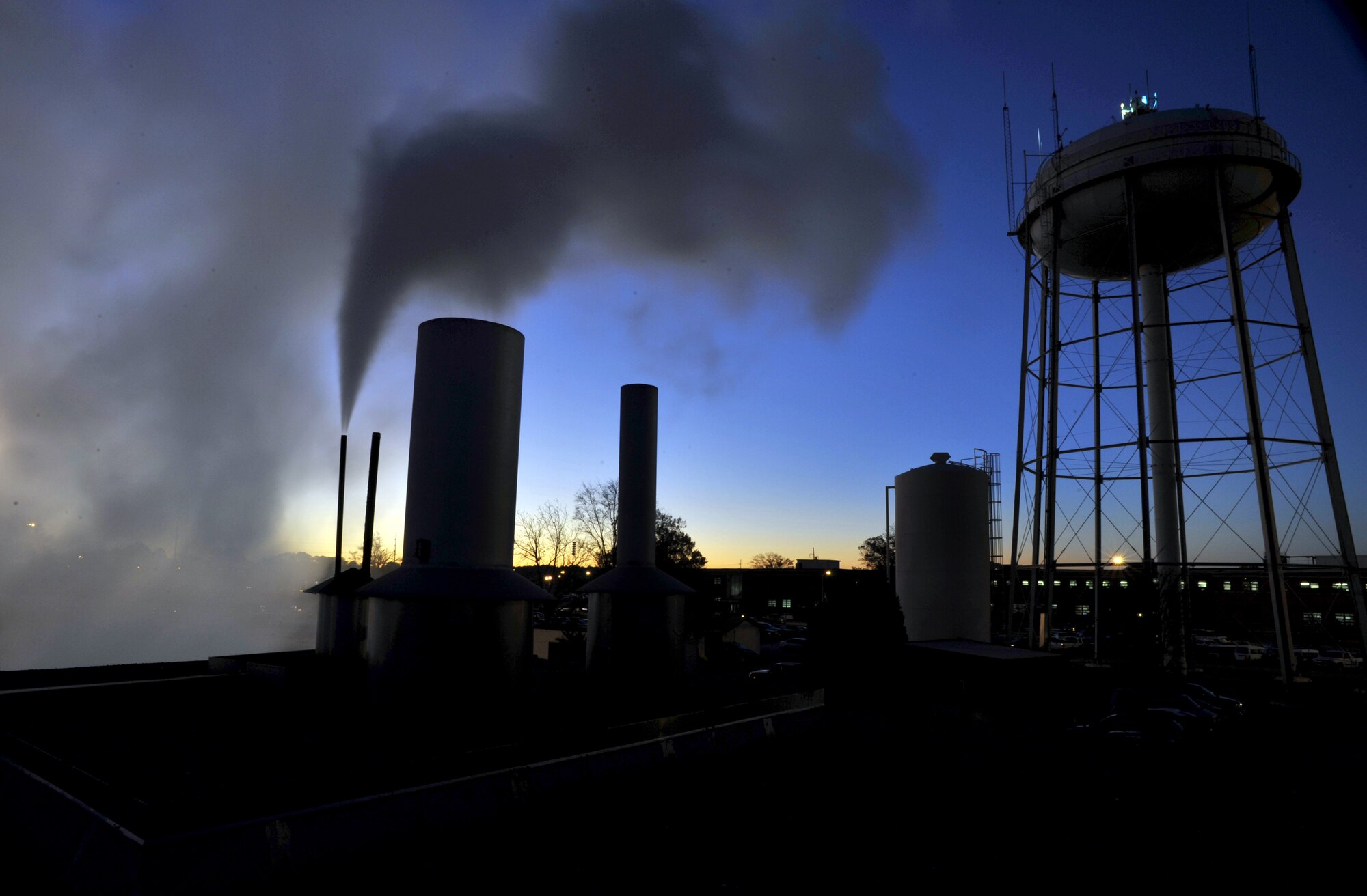 Steam rises from the roof of the steam plant (Building 177) at day break over Warner Robins Air Logistics Center Dec. 8.  U. S. Air Force photo by Claude Lazzara