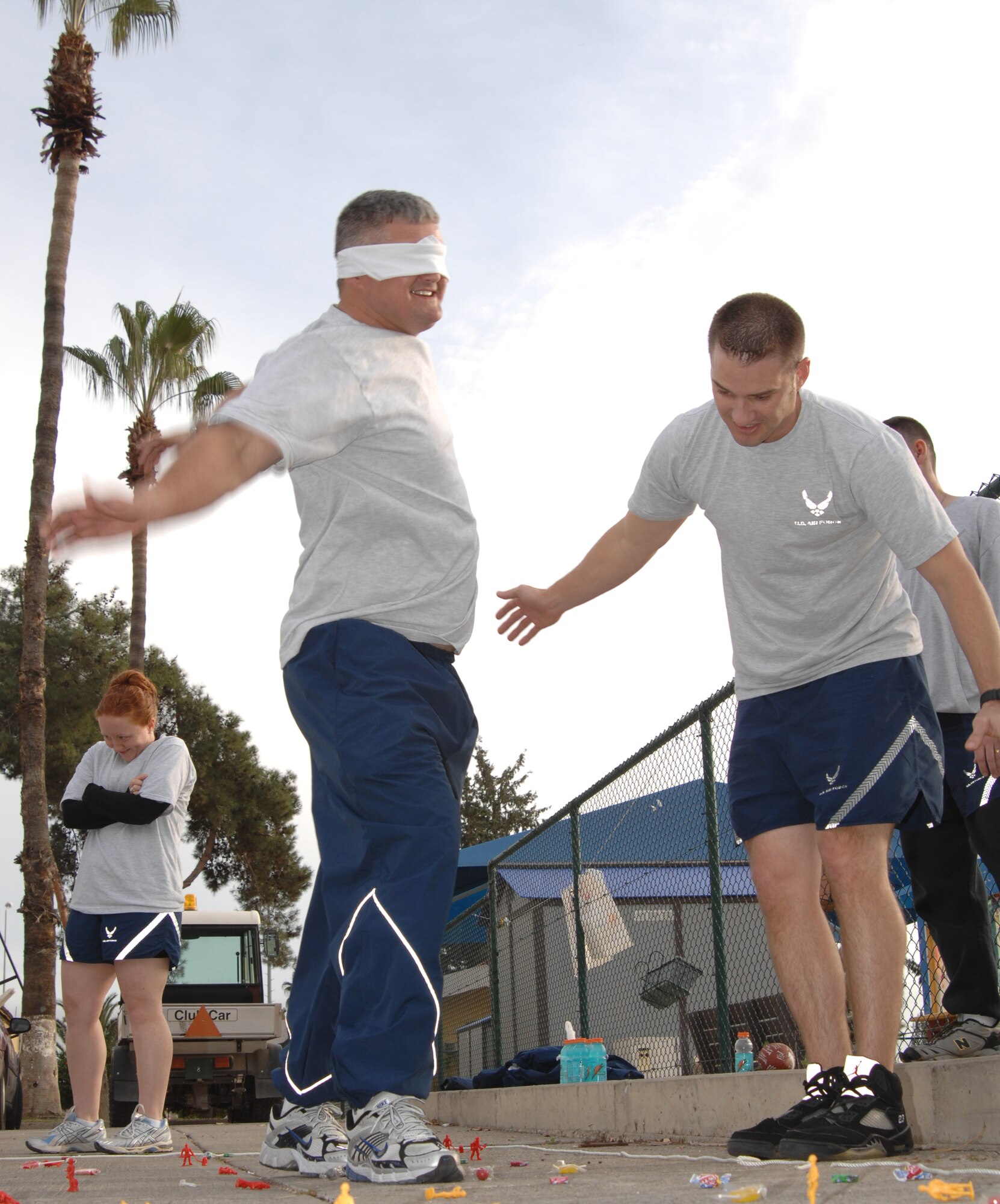 Tech. Sgt. Russell Cooper, 39th Air Base Wing Safety, tries to regain his balance while Tech. Sgt. Dustin Stull, 39 ABW chapel, encourages him during a game of mine field, Dec. 5. Mine field was a team-building exercise designed to demonstrate the importance of communication.