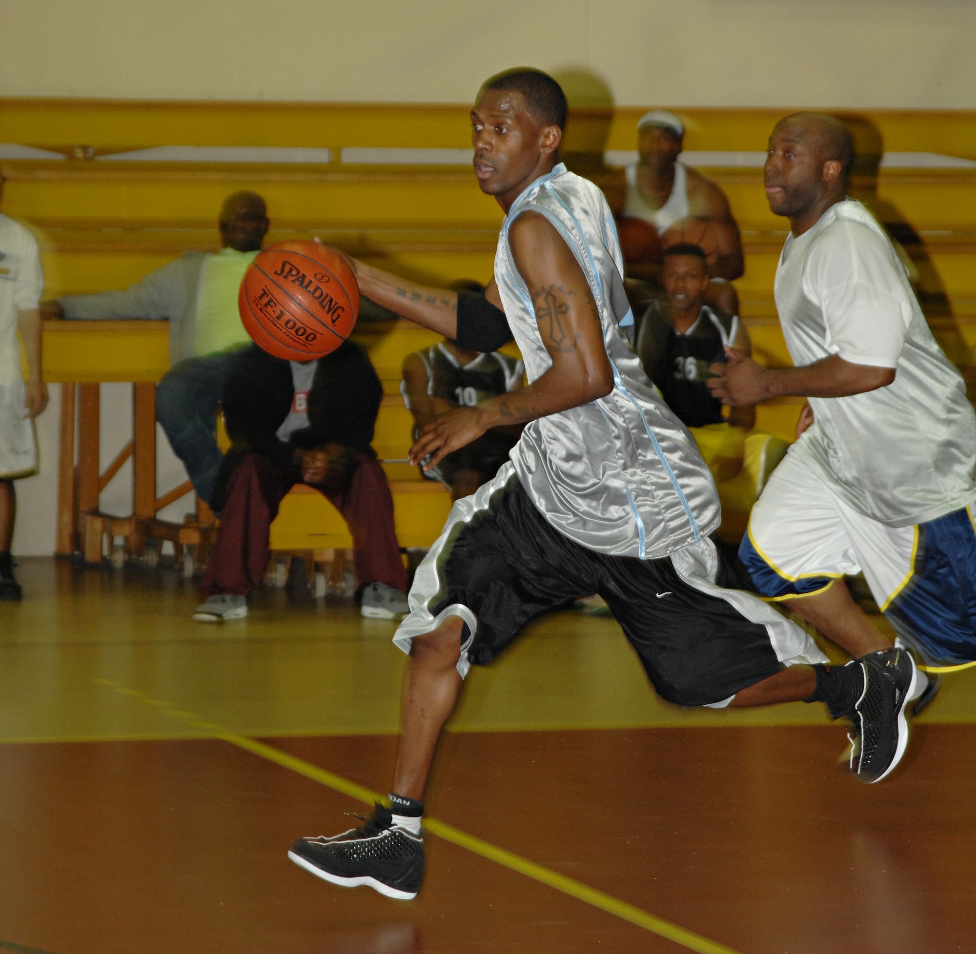 Timothy Comer, 39th Security Forces Squadron, dribbles down the court after a turn-over during an Incirlik intramural basketball game, Dec. 4. Comer plays for the 39th Civil Engineering/Operations Squadron team shook off the Logistic Readiness Squadron team 59 – 56. (U.S. Air Force photo by Senior Airman Benjamin Wilson)