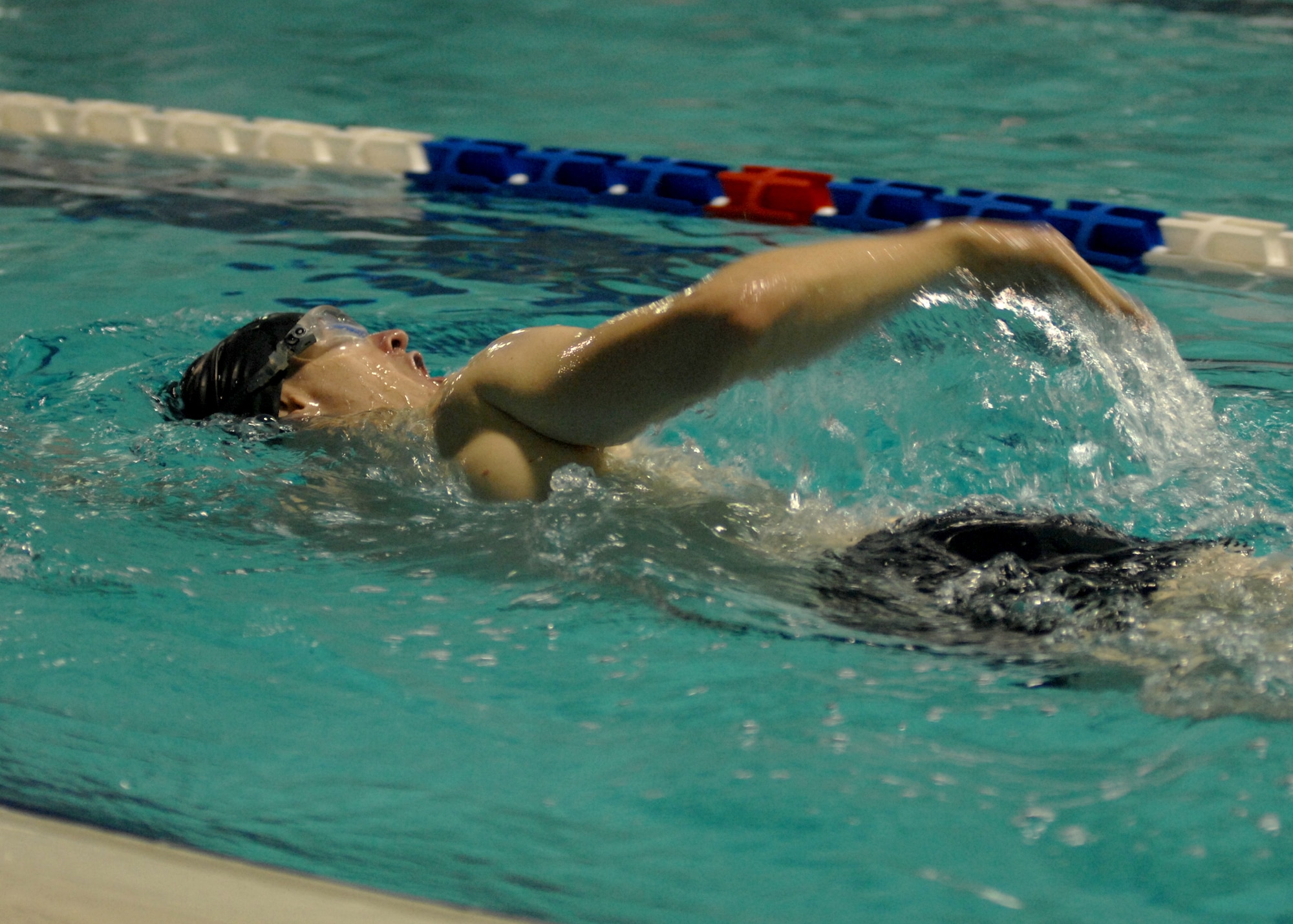A male swimmer from Aviano Air Base gets an early morning workout Nov. 25 at the local indoor pool in Aviano. Military identifcation card holders from the base can lap swim at no charge during designated hours. Swimmers must, at a minimum, wear flip flops or shower shoes, a swim cap, goggles and appropriate swim attire.  (U.S. Air Force photo/Airman 1st Class Tabitha Mans)