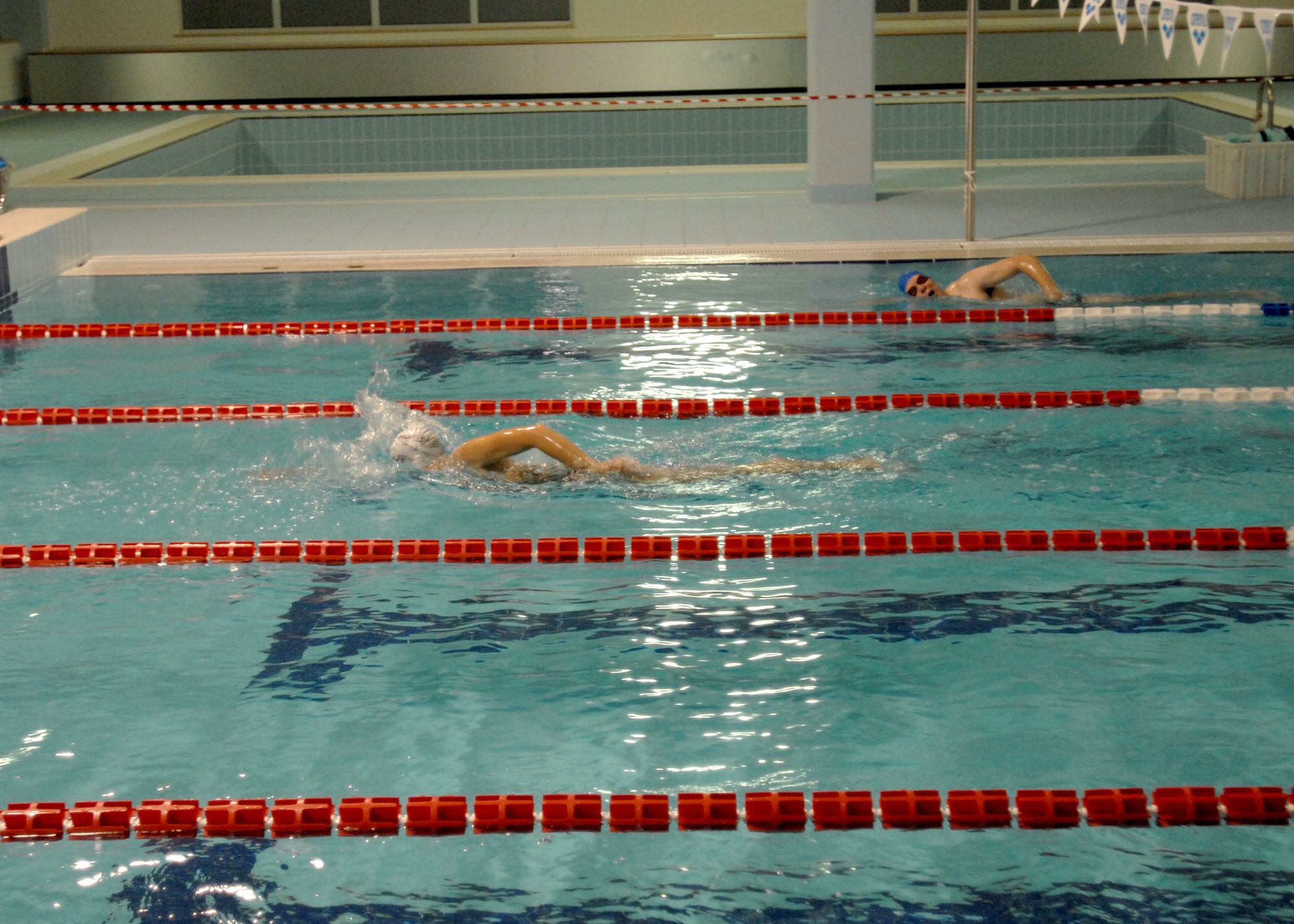 Swimmers from Aviano Air Base get an early morning workout Nov. 25 at the local indoor pool in Aviano. Military identifcation card holders from the base can lap swim at no charge during designated hours. Swimmers must, at a minimum, wear flip flops or shower shoes, a swim cap, goggles and appropriate swim attire. (U.S. Air Force photo/Airman 1st Class Tabitha Mans)