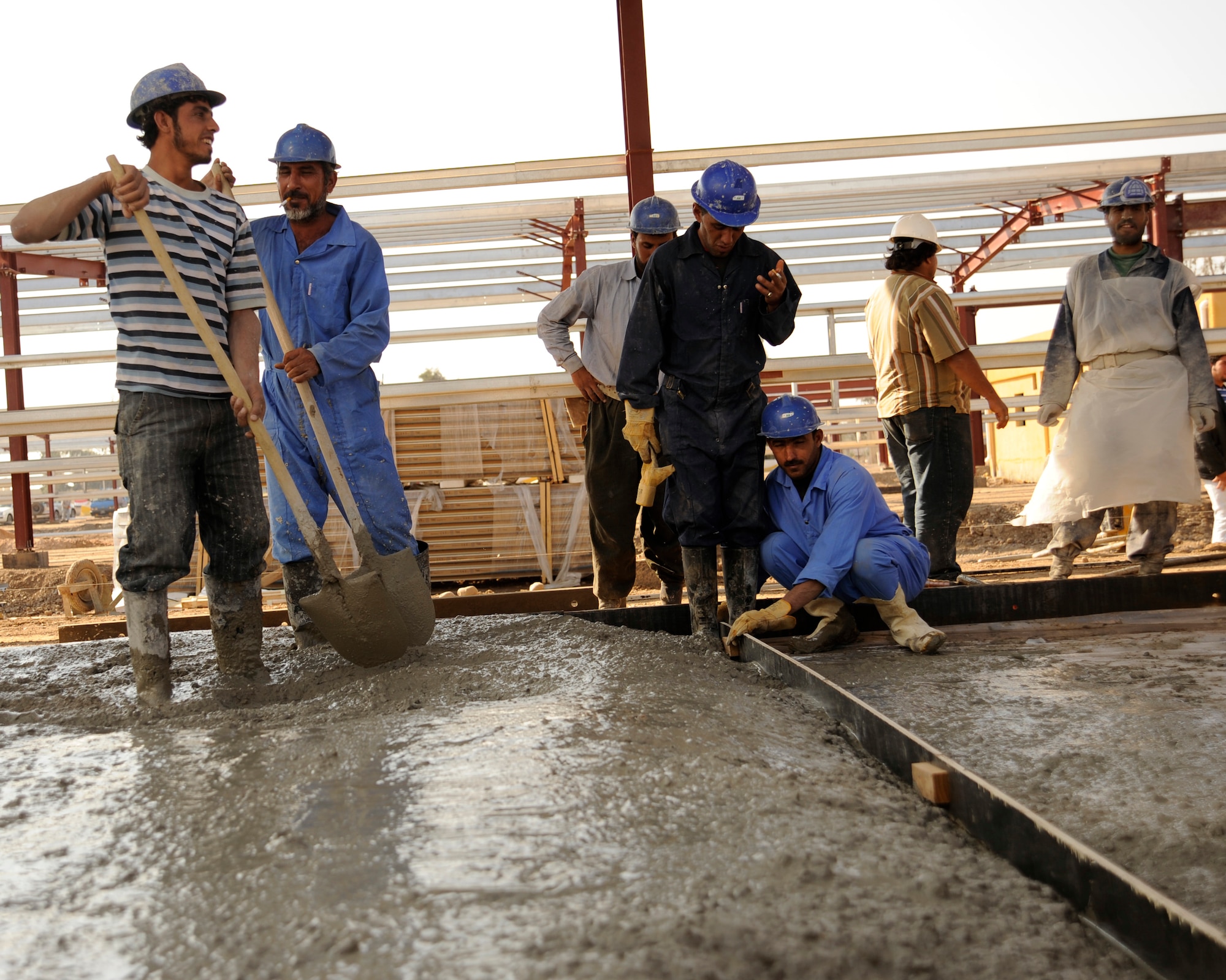 Iraqi construction workers pour concrete during the building of barracks on Taji Military Base, Iraq on Nov. 24. (U.S. Air Force photo/Staff Sgt. Paul Villanueva II)
