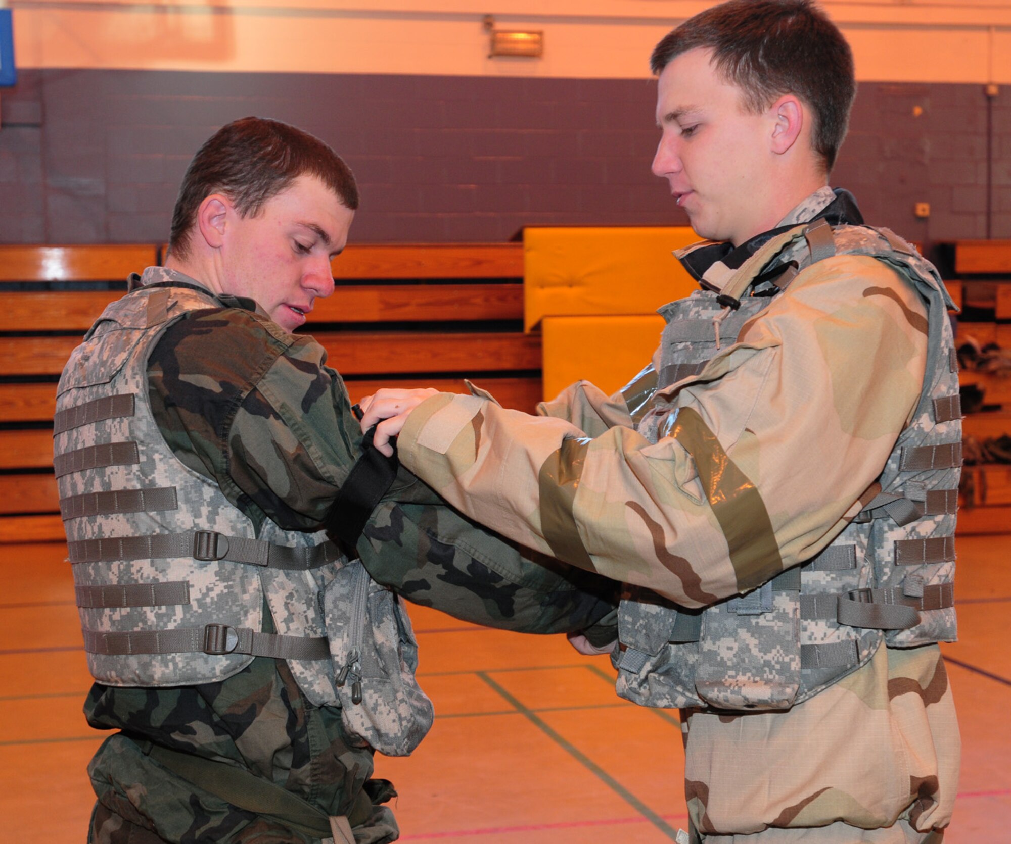 Airman Garrett Walker, right, applies a tourniquet to Airman Taylor Russell, both 100th Security Forces Squadron, during the self-aid, buddy-care portion of the ATSO Rodeo at the Main Fitness Center Dec. 5. The ATSO refresher training was held for base personnel participating in the Phase I and II exercise Dec. 8 to 12. (U.S. Air Force photo by Karen Abeyasekere)