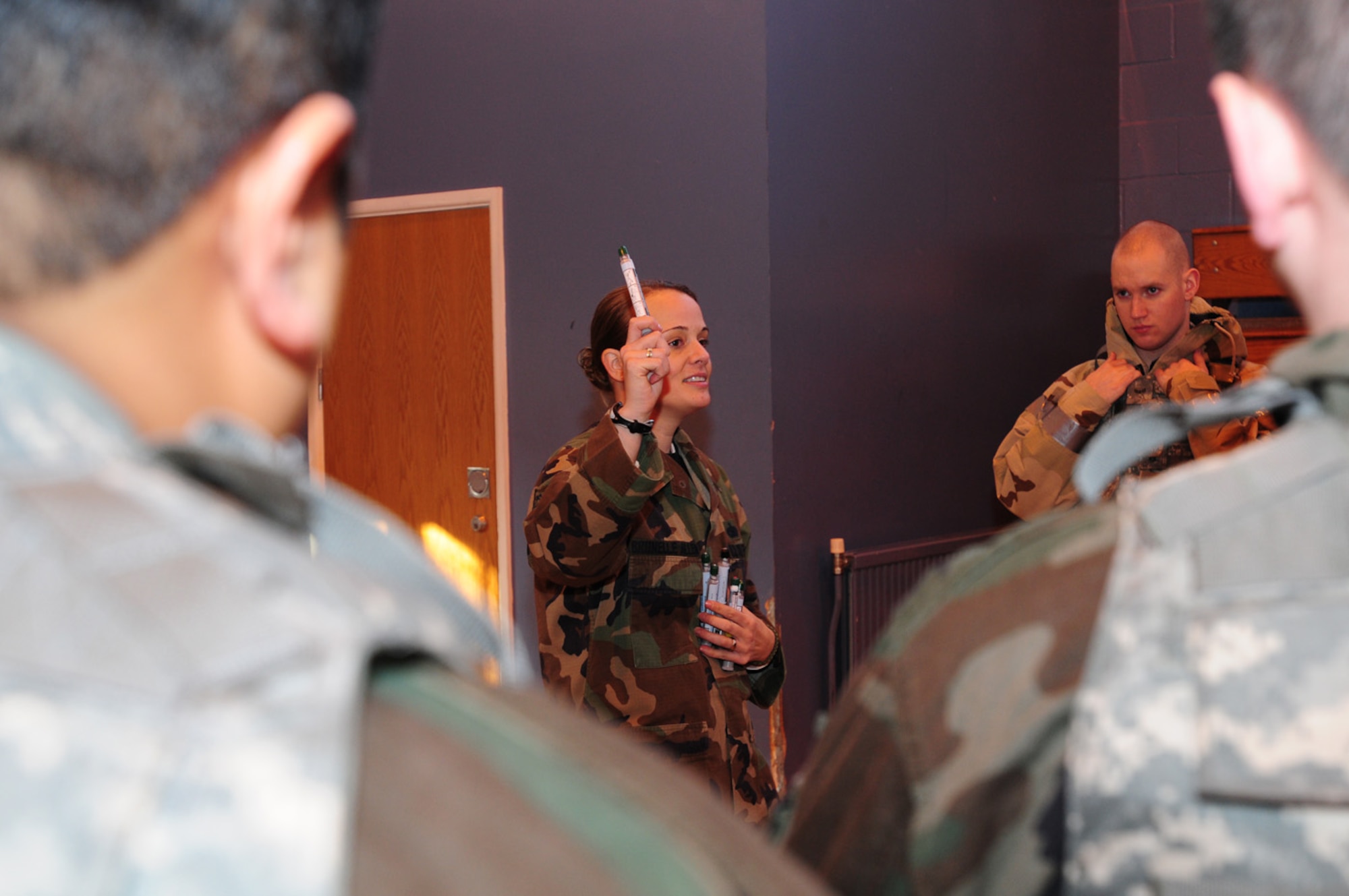 Staff Sgt. Valerie Brunelle-Allen, 100th Security Forces Squadron, demonstrates how to administer a nerve agent treatment using ATNAA (Antidote Treatment, Nerve Agent, Auto-injector) during the ATSO Rodeo at the Main Fitness Center Dec. 5. The ATSO refresher training was held for base personnel participating in the Phase I and II exercise Dec. 8 to 12. Training consisted of hands-on self-aid buddy care practice, unexploded ordnance identification and procedures, pre-, trans- and post-attack actions, and a contamination control area. (U.S. Air Force photo by Karen Abeyasekere) 