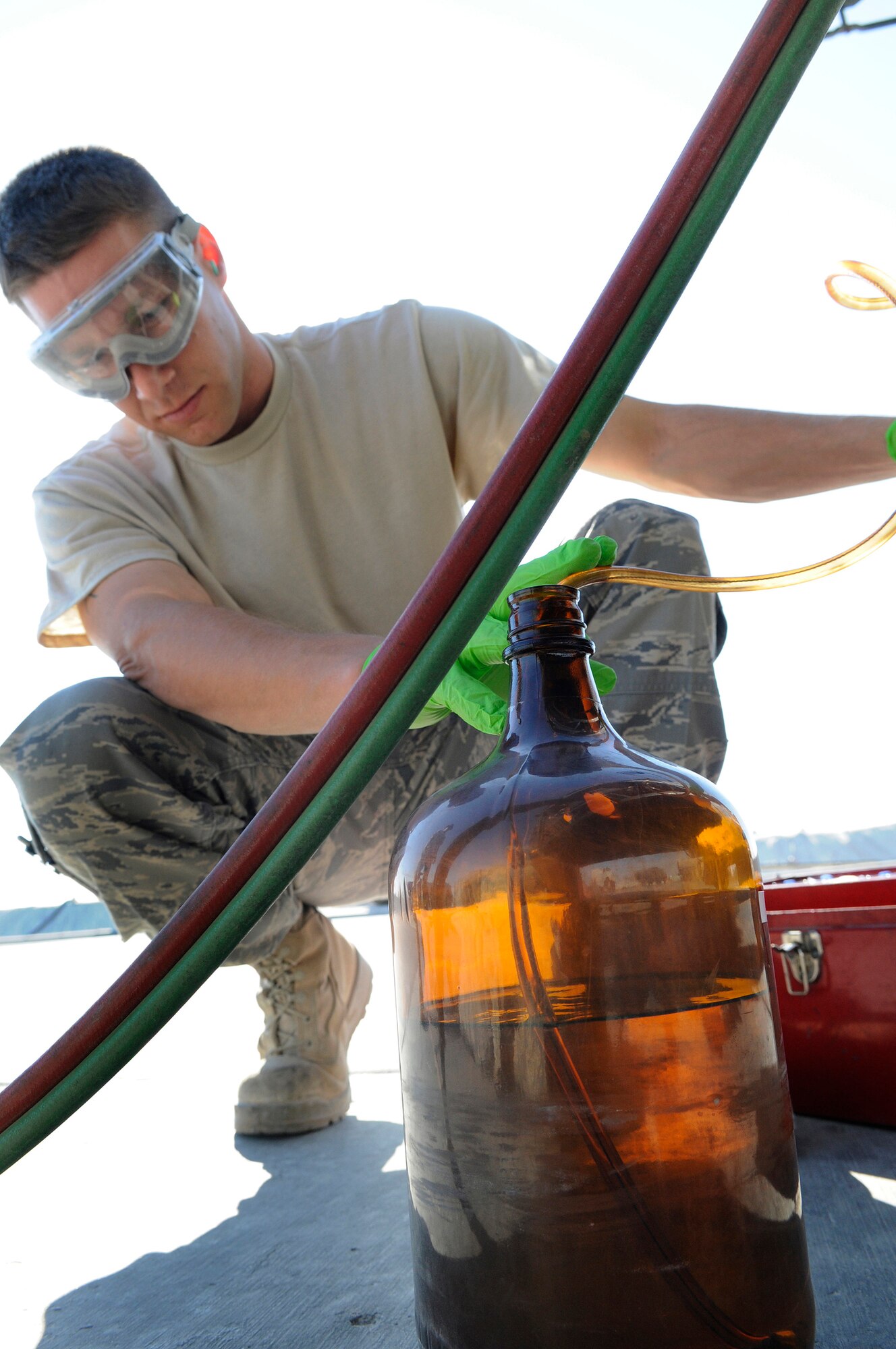 Staff Sgt. Ronald Gasper, a fuels lab technician assigned to the 379th Expeditionary Logistics Readiness Squadron, fills a bottle with JP-8 fuel to perform a bottle method test, Dec. 8, at an undisclosed air base in Southwest Asia. The bottle method test is used to test a fuel truck's filter separator and measures the amount of impurities in the fuel.  Sergeant Gasper, a native of Omaha, Neb., is deployed from Scott Air Force Base, Ill., in support of Operations Iraqi and Enduring Freedom and Joint Task Force-Horn of Africa.  (U.S. Air Force photo by Tech. Sgt. Michael Boquette/Released)