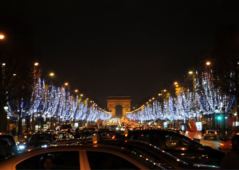 Paris' tree-lined street, the Champs-Elyses, sparkles Nov. 28.  The Champs leads to the Napoleanic war memorial Arc de Triomphe.  Visitors can peruse restaurants, stores such as Luis Vuitton, movie theaters and more.  Wooden Christmas shops and games also line the street this time of year.  At the other end, visitors can see the giant ferris wheel. (U.S. Air Force photo by 2nd Lt. Kathleen Ferrero)