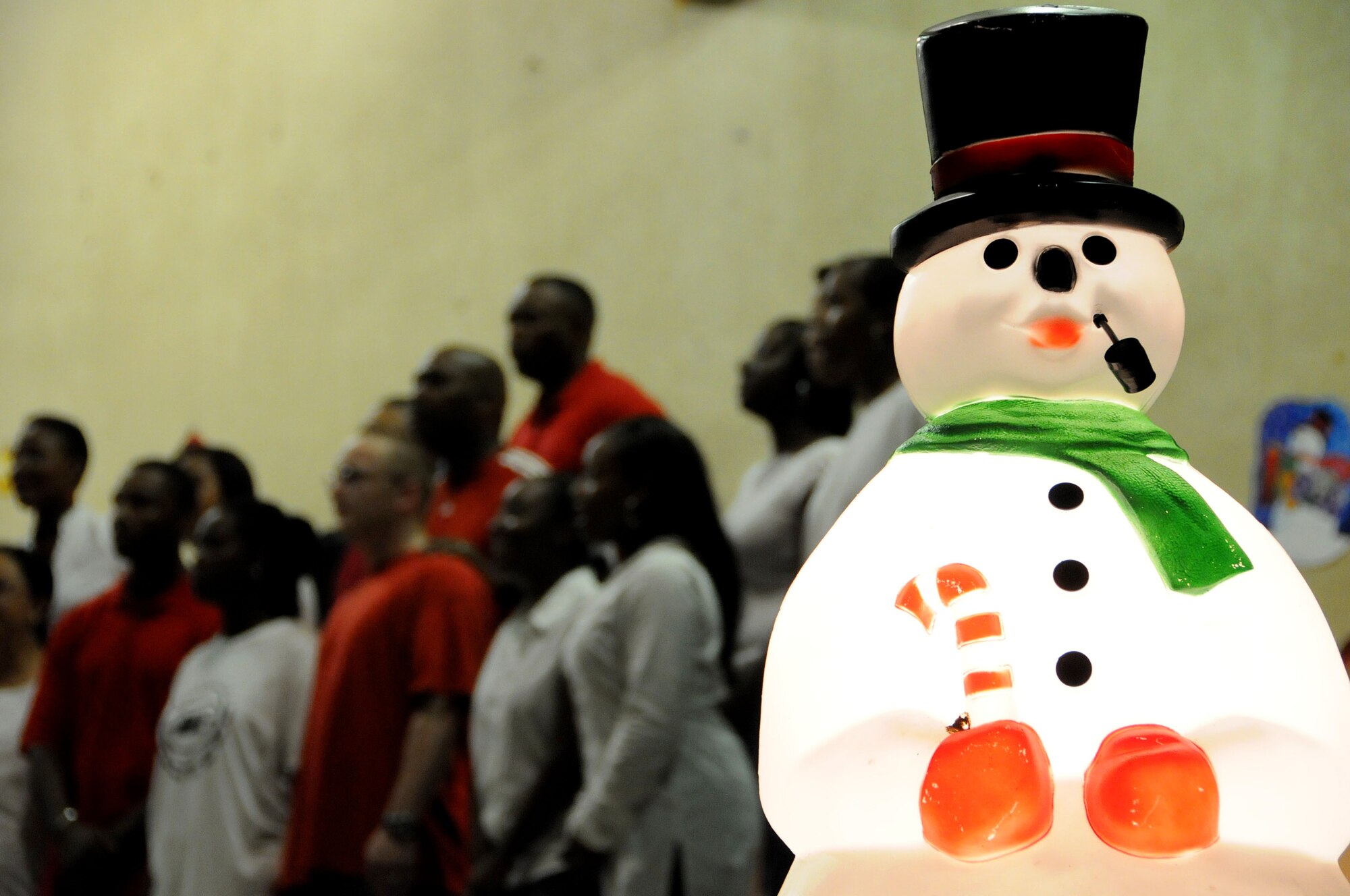 ANDERSEN AIR FORCE BASE, Guam - As frosty looks on, a gospel choir belts out a joyful tune here Dec. 4 during the Christmas Tree Lighting celebration. Guests were able to listen to a wide variety of music during the event. (U.S. Air Force photo by Airman 1st Class Courtney Witt)
