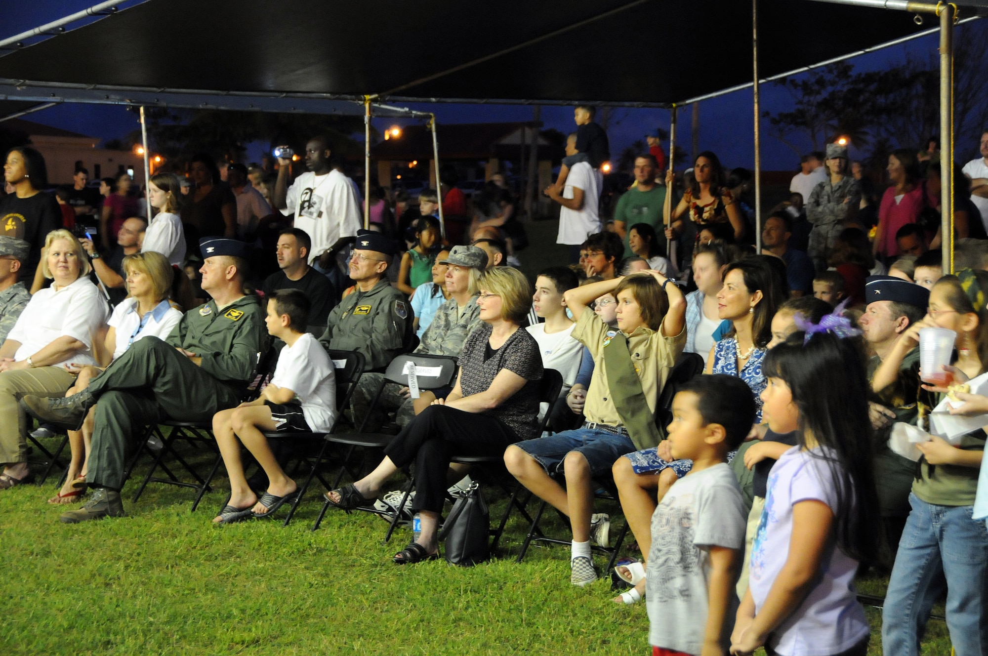 ANDERSEN AIR FORCE BASE, Guam - Commanders, their families and other guests enjoy the festivities at this year’s Christmas Tree Lighting celebration here Dec. 4. On-lookers enjoyed caroling, gospel choir, solos, lighting of the tree and last but not least Santa Claus. (U.S. Air Force photo by Airman 1st Class Courtney Witt)
