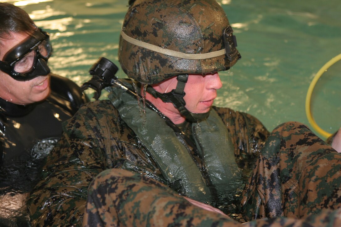 Lance Cpl. Kyle A. Seffels, a mortarman with Weapons Company, Battalion Landing Team, 3rd Battalion, 2nd Marine Regiment, 22nd Marine Expeditionary Unit, and native of Fayetteville, N.C., prepares to submerge upside-down during the Shallow Water Egress Training course, Dec. 8 - 9, 2008, aboard Camp Lejeune, N.C. The course taught the Marines to escape a helicopter in the event of a water landing. (Official Marine Corps photo by Lance Cpl. Alicia R. Giron)