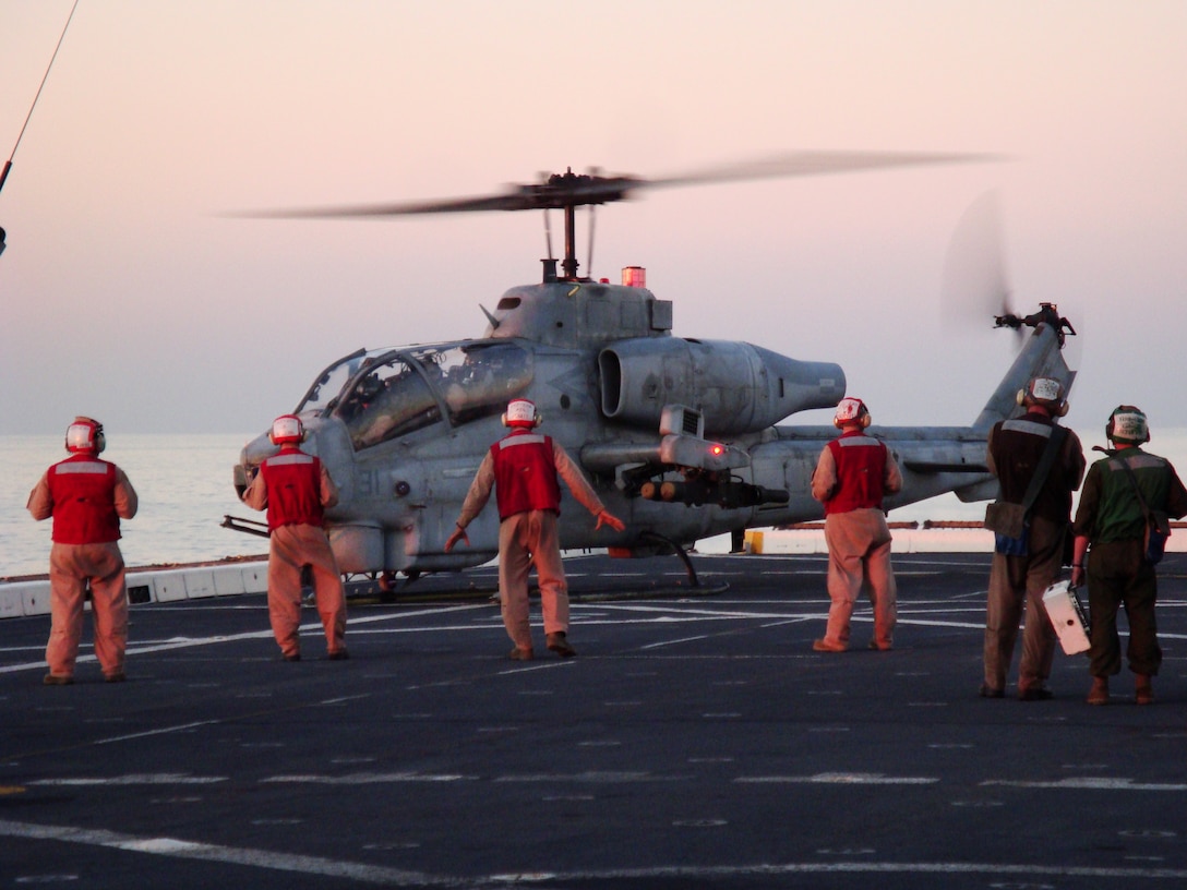 An AH-1W Super Cobra attack helicopter prepares to take off from the flight deck of USS San Antonio, Nov. 9, 2008. Approximately 75 Marines with HMM-264, the Aviation Combat Element of the 26th Marine Expeditionary Unit, flew to the San Antonio to practice flying "skids," or non-wheeled aircraft like the Cobra and UH-1N Huey from the new ship.