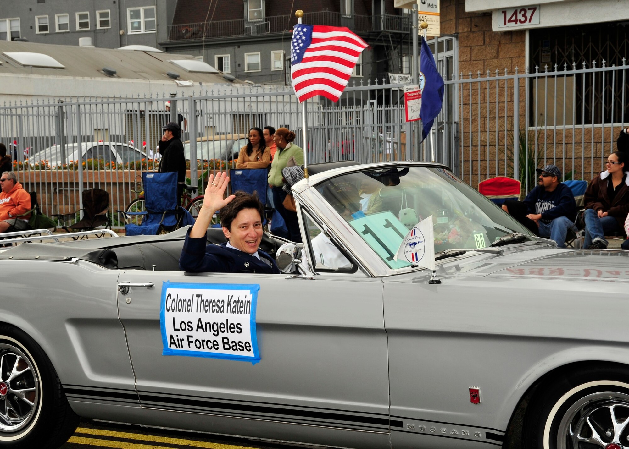 Col. Theresa Katein, 61st Mission Support commander, rode in a vintage Mustang in the San Pedro Holiday Parade, Dec. 7.  An Honor Guard and a cheerleading squad also represented the base in the annual event, which included local dignitaries, marching bands and community groups. (Photo by Lou Hernadez)