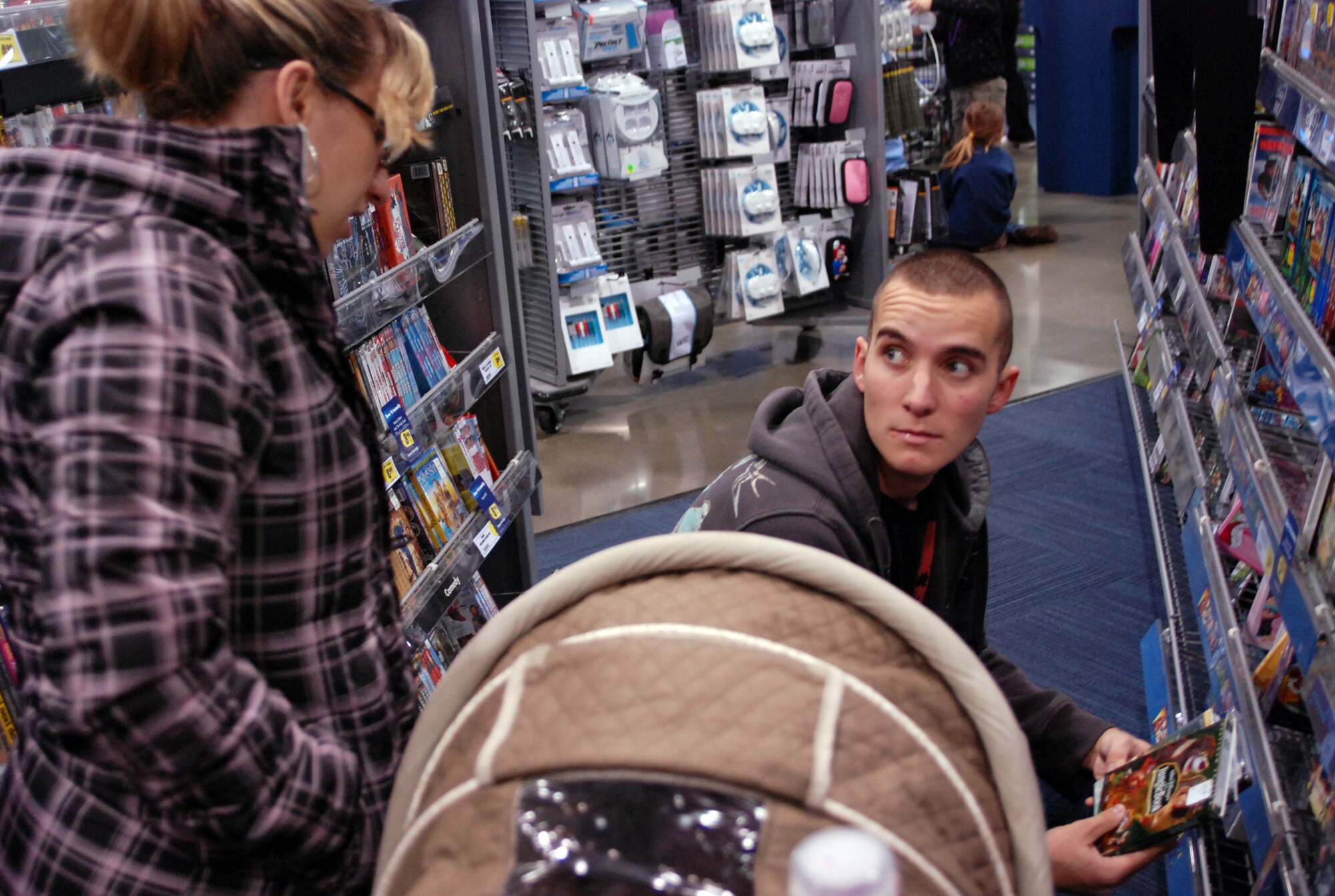 Airman 1st Class Brandon Gomez, 9th Security Forces Squadron, and his wife Adrienne, shop for movies during their Best Buy shopping spree Dec. 7 courtesy of Spencer Hawes, center for the Sacramento Kings.  (Photo by Staff Sgt. Sarah Gregory)