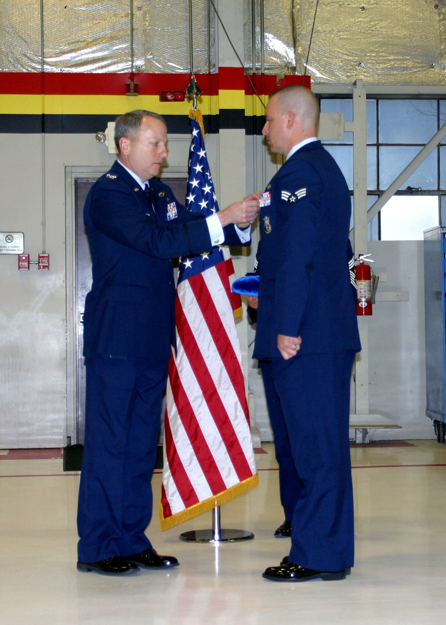 Col. Walter “Buck” Sams, 419th Fighter Wing commander, presents the Air Force Combat Action Medal to Senior Airman Thomas Benincosa of the 419th Security Forces Squadron, who deployed to Kirkuk, Iraq early this year in support of Operation Iraqi Freedom. While working a night shift in a tower along the base perimeter, Airman Benincosa repelled an enemy attack on his post, which earned him the distinguished medal, as well as accolades for his valiant efforts in the Global War on Terror. (U.S. Air Force photo)
