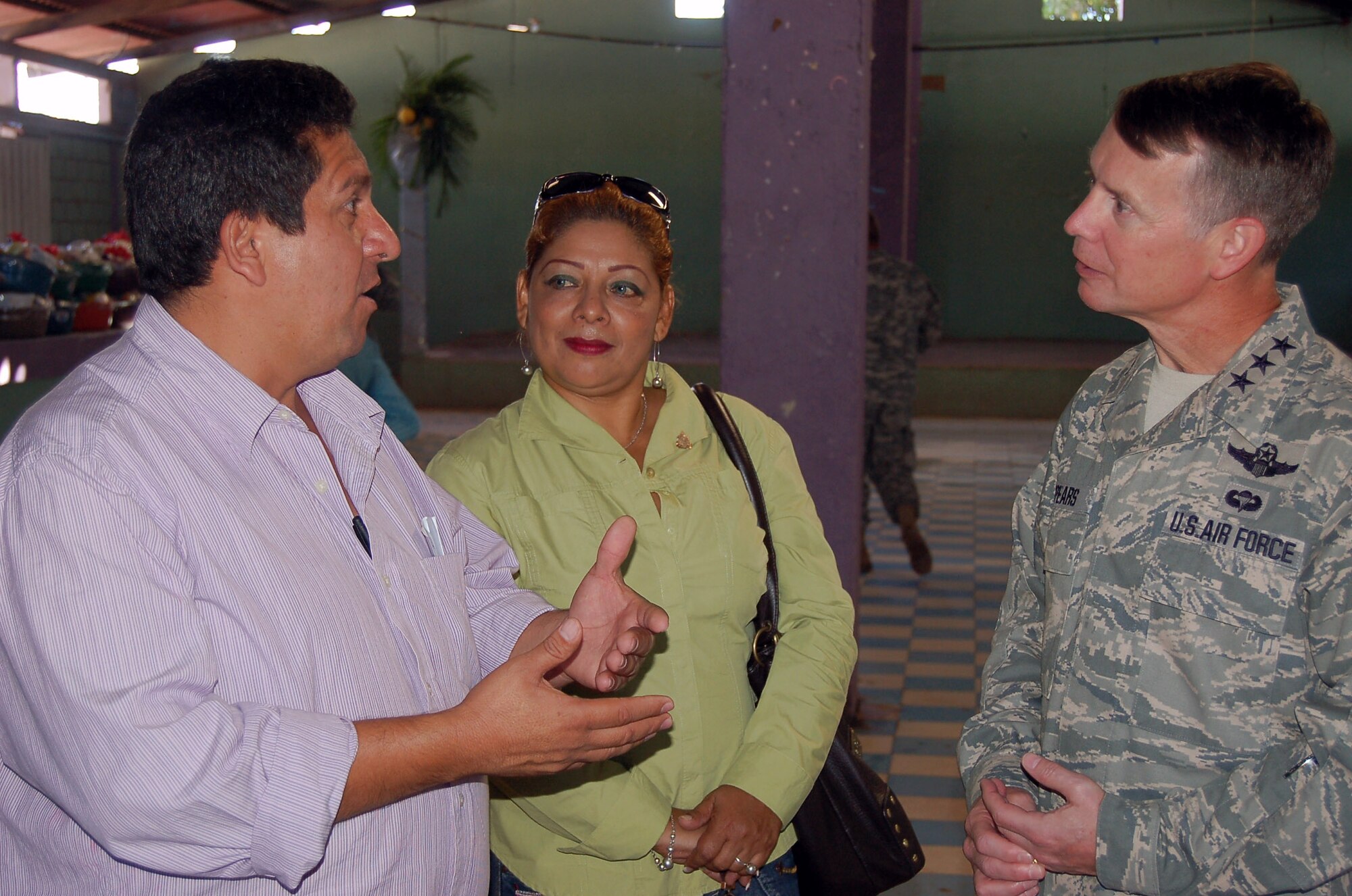 Mario Palencia, the Mayor of Ajuterique (left), and Maria Martinez, governor of Comayagua expressed their gratitude to Lt. Gen. Glenn Spears, U.S. Southern Command deputy commander, Dec. 9, for help at Ajuterique, Honduras. The town contains 11,000 people affected by a recent flooding. The group handed out food-laden gift baskets to the ones hardest hit. (U.S. Air Force photo)