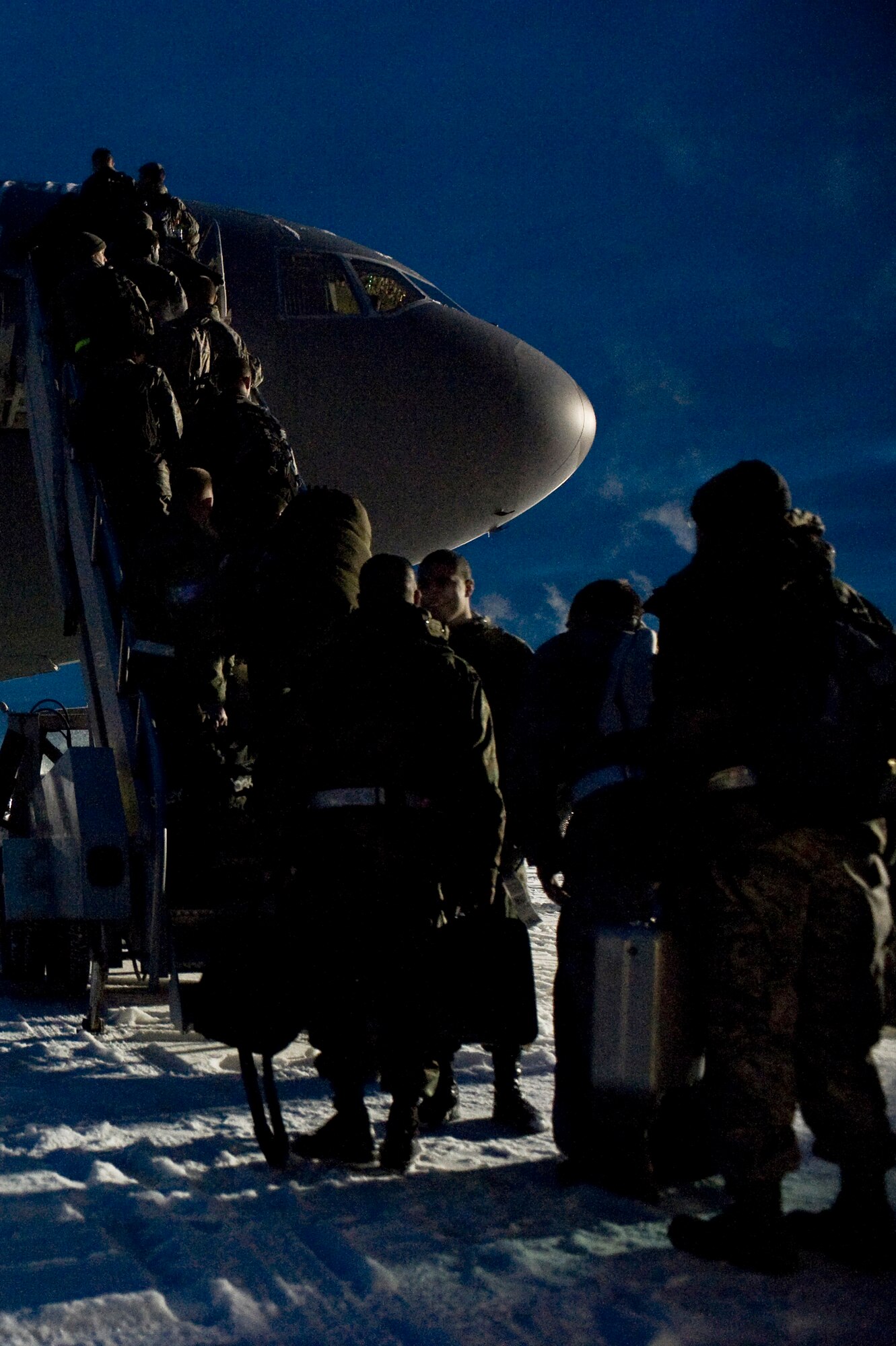 Airmen of the 354th Aircraft Maintenance Squadron board a KC-10 Extender Dec. 4 as they depart Eielson Air Force Base, Alaska. They left for Hickam AFB, Hawaii, where the members of the 18th Aggressor Squadron will provide expert threat academics Pacific Air Forces pilots. (U.S. Air Force photo/Senior Airman Jonathan Snyder) 
