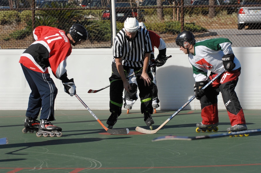 HURLBURT FIELD, Fla. -- Senior Airman Brian Wendt, 1st Special Operations Security Forces Squadron, and a member of the South Florida Samurai Squirrels face off during a game here, Nov. 8. The exhibition game between the Puck Divers and the Samurai Squirrels was held promote the new league starting at Hurlburt Field at the beginning of 2009. (U.S. Air Force photo /Senior Airman Julianne Showalter)