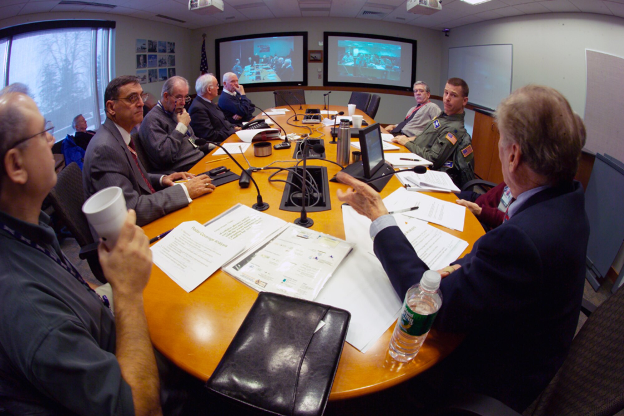 Members of the Iraq Air Sovereignty Master Plan team from ESC and MITRE present a briefing from MITRE’s Bedford campus to the Iraqi Air Force Defense Group in the Baghdad Air Operations Center.  (Photo courtesy of the MITRE Corp.)