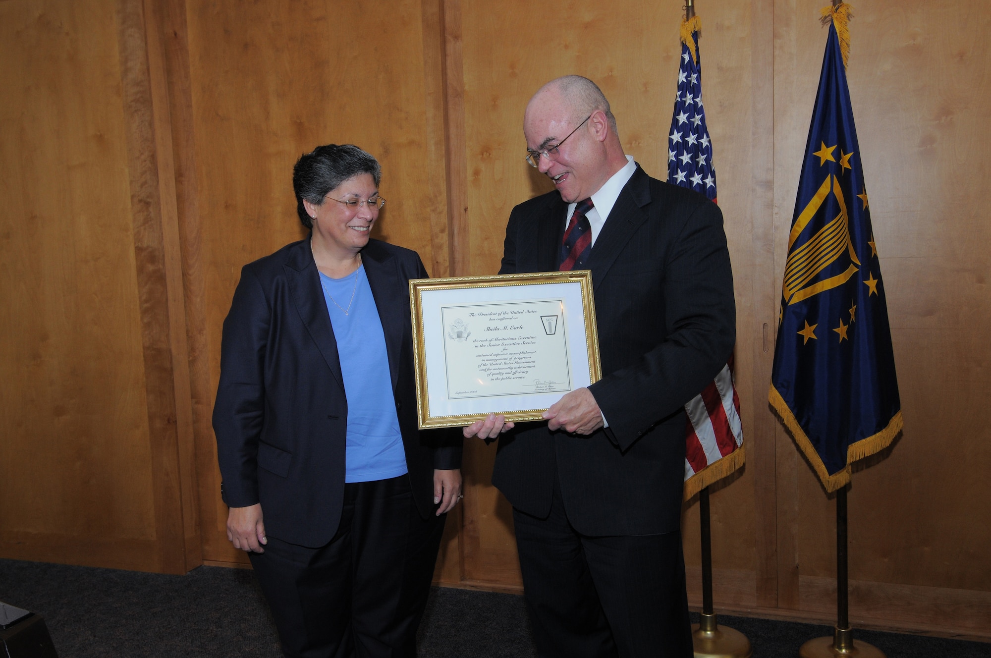 Bill Carr, deputy undersecretary, military personnel policy, Office of the Secretary of Defense, presents a Presidential Rank Award to Sheila Earle, Air Force Personnel Center executive director, during a ceremony Dec. 9. Ms. Earle was conferred the rank of "Meritorious Executive in the Senior Executive Service" for her accomplishments in U.S. Government program management and for her quality and efficiency in service to the public. (U.S. Air Force photo by Melissa Peterson)

