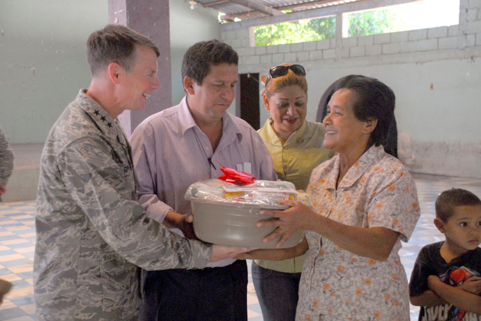 AJUTERIQUE, Honduras - Air Force Lt. Gen. Glenn Spears, U.S. Southern Command deputy commander, hands a local woman a free gift basket Dec. 9 here. The baskets, which contained essential food and supplies, were given to more than 100 local families who were recently affected by widespread flooding in Honduras. (U.S. Air Force photo by Staff Sgt. Joel Mease) 