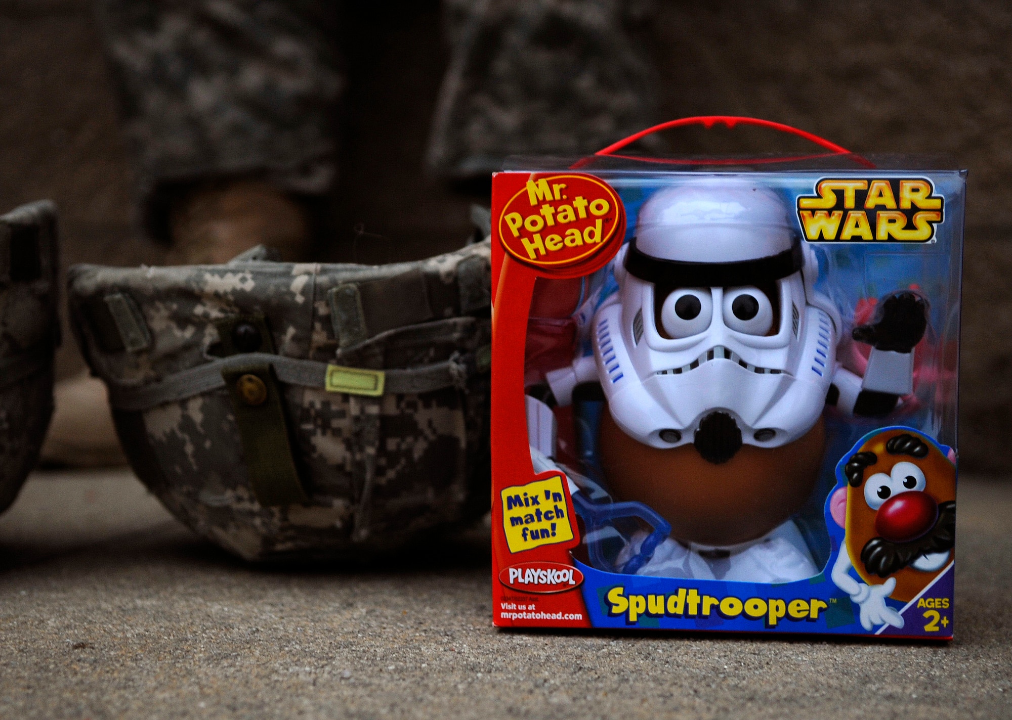 Toys sit on the sidewalk as Army Soldiers from the 82nd Airborne Division from Fort Bragg, N.C., wait in line to donate a toy and a chance to be picked in a lottery for an opportunity to earn foreign jump wings Dec. 5 during Operation Toy Drop at Pope Air Force Base, N.C. Operation Toy Drop is an annual Airborne jump at Fort Bragg in its 11th year hosted by the Army Civil Affairs and Psychological Operations Command (Airborne), and supported by Fort Bragg's XVIII Airborne Corps and the Air Force Reserve Command's 440th Airlift Wing that gives Soldiers and Airmen the opportunity to help local families in need over the holidays while boosting morale and incorporating valuable training. More than 3,000 Soldiers donated a toy for a lottery ticket and the chance to jump under a foreign jumpmaster, earning them their foreign jump wings. This year, German and Irish jumpmasters will be issuing the commands from C-130 Hercules aircraft during the operation. (U.S. Air Force photo/Tech. Sgt. Jeremy Lock) 
