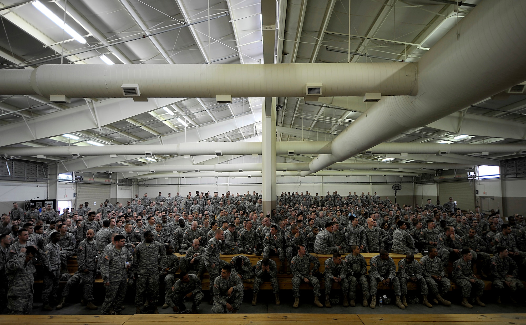 Soldiers from the 82nd Airborne Division from Fort Bragg, N.C., listen for their lottery number to be called for a chance to jump and earn foreign jump wings after donating a toy Dec. 5 during Operation Toy Drop at Pope Air Force Base, NC. Operation Toy Drop is an annual Airborne jump at Fort Bragg in its 11th year hosted by the Army Civil Affairs and Psychological Operations Command (Airborne), and supported by Fort Bragg's XVIII Airborne Corps and the Air Force Reserve Command's 440th Airlift Wing at Pope AFB that gives Soldiers and Airmen the opportunity to help local families in need over the holidays while boosting morale and incorporating valuable training. More than 3,000 Soldiers donated a toy for a lottery ticket and the chance to jump under a foreign jumpmaster, earning them their foreign jump wings. This year, German and Irish jumpmasters will be issuing the commands from C-130 Hercules aircraft during the operation. (U.S. Air Force photo/Tech. Sgt. Jeremy Lock) 
