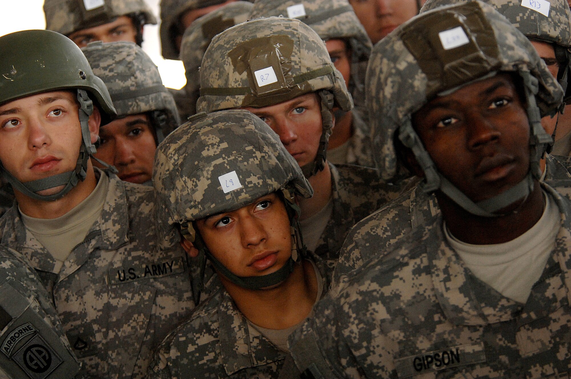 Soldiers from the Army's 82nd Airborne Division from Fort Bragg, N.C., listen to the jumpmaster while attending parachute landing fall class Dec. 5 before their jump for Operation Toy Drop at Pope Air Force Base, N.C. Operation Toy Drop is an annual Airborne jump at Fort Bragg in its 11th year hosted by the Army Civil Affairs and Psychological Operations Command (Airborne), and supported by Fort Bragg's XVIII Airborne Corps and the Air Force Reserve Command's 440th Airlift Wing at Pope AFB that gives Soldiers and Airmen the opportunity to help local families in need over the holidays while boosting morale and incorporating valuable training. More than 3,000 Soldiers donated a toy for a lottery ticket and the chance to jump under a foreign jumpmaster, earning them their foreign jump wings. This year, German and Irish jumpmasters will be issuing the commands from C-130 Hercules aircraft during the operation. (U.S. Air Force photo/Tech. Sgt. Jeremy Lock) 
