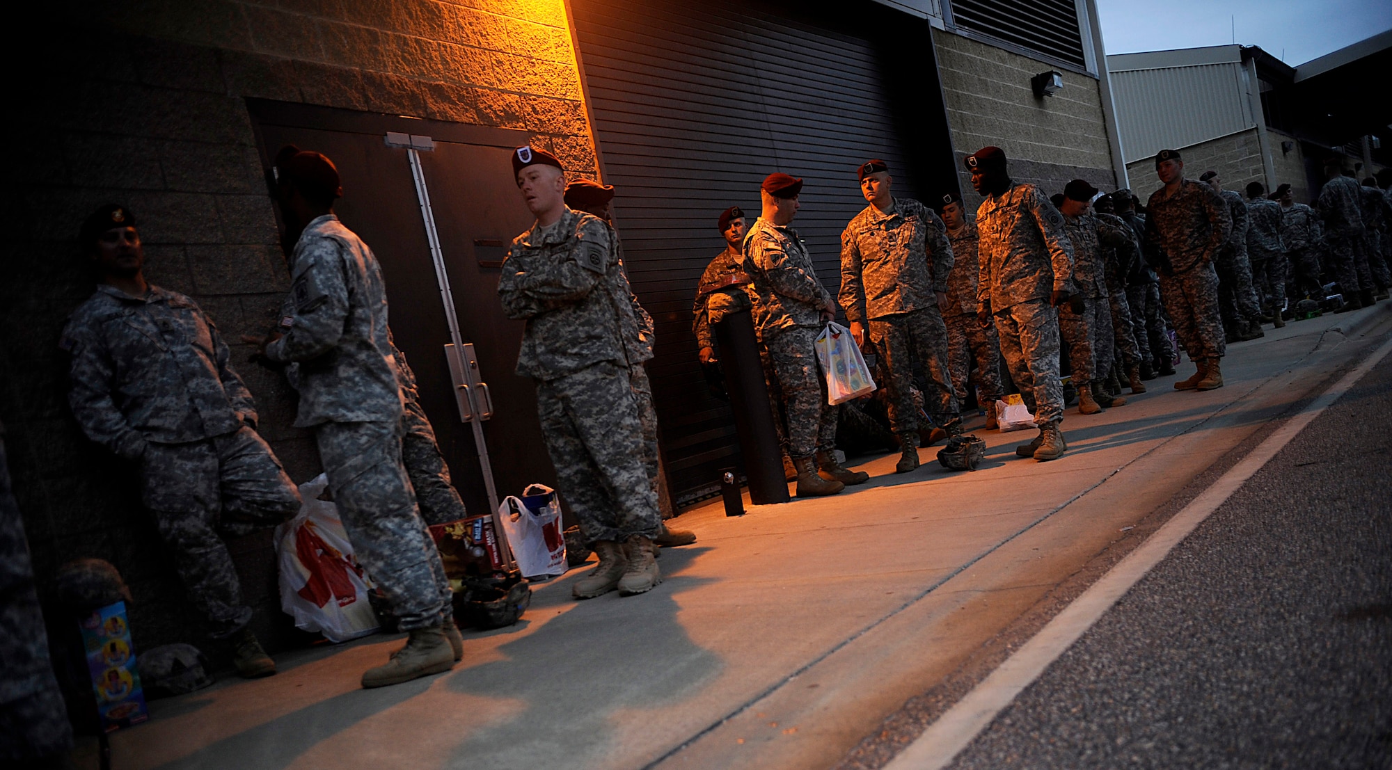 Soldiers from the 82nd Airborne Division from Fort Bragg, N.C., wait in line to donate the toys and a chance to be picked in a lottery for an opportunity to earn foreign jump wings Dec. 5 at Pope Air Force Base, N.C. Operation Toy Drop is an annual Airborne jump at Fort Bragg in its 11th year hosted by the Army Civil Affairs and Psychological Operations Command (Airborne), and supported by Fort Bragg's XVIII Airborne Corps and the Air Force Reserve Command's 440th Airlift Wing at Pope AFB that gives Soldiers and Airmen the opportunity to help local families in need over the holidays while boosting morale and incorporating valuable training. More than 3,000 Soldiers donated a toy for a lottery ticket and the chance to jump under a foreign jumpmaster, earning them their foreign jump wings. This year, German and Irish jumpmasters will be issuing the commands from C-130 Hercules aircraft during the operation. (U.S. Air Force photo/Tech. Sgt. Jeremy Lock) 