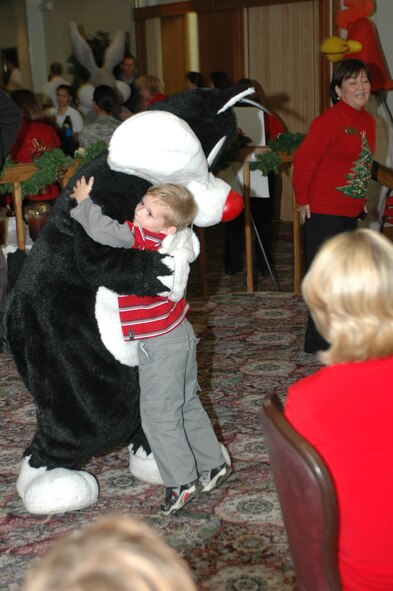 Justin Welch, 5, welcomes Sylvester the Cat with a big hug at this year’s Special Needs Holiday Party Dec. 9 at the Travis Conference Center. The event in its second year, pays tribute to Travis’ special needs families, by providing them with dinner, entertainment and gifts. This year, characters from Six Flags Discovery Kingdom, were on hand to visit with the children.  (U.S. Air Force photo/Staff Sgt. Shaun Emery)
