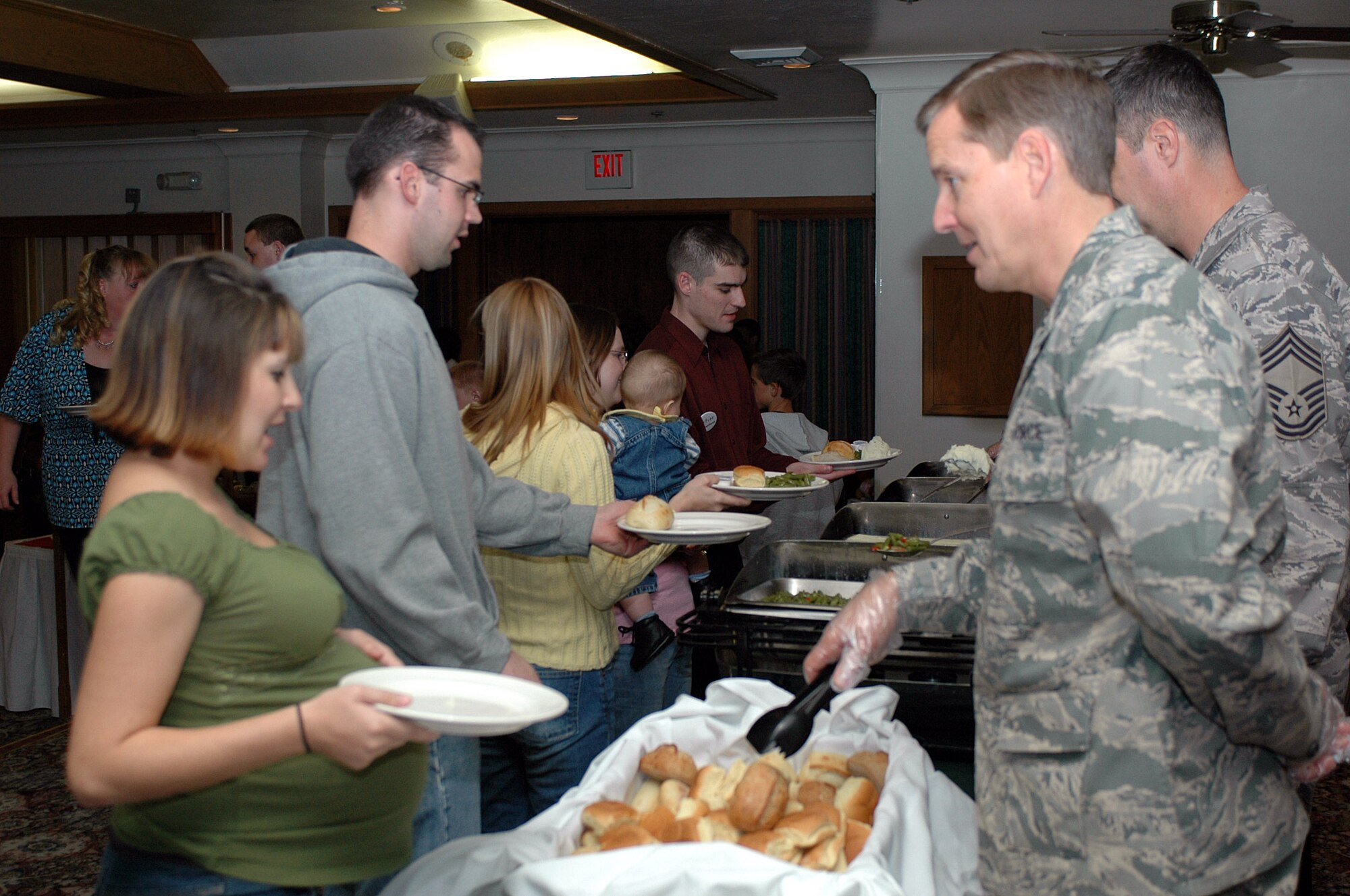Col. Frank Budd, 60th Medical Group’s Mental Health Clinic flight commander, serves dinner at this year’s Special Needs Holiday Party Dec. 9 at the Travis Conference Center. More than 225 members of the Team Travis community came out to celebrate Travis’ special needs families. (U.S. Air Force photo/Staff Sgt. Shaun Emery)