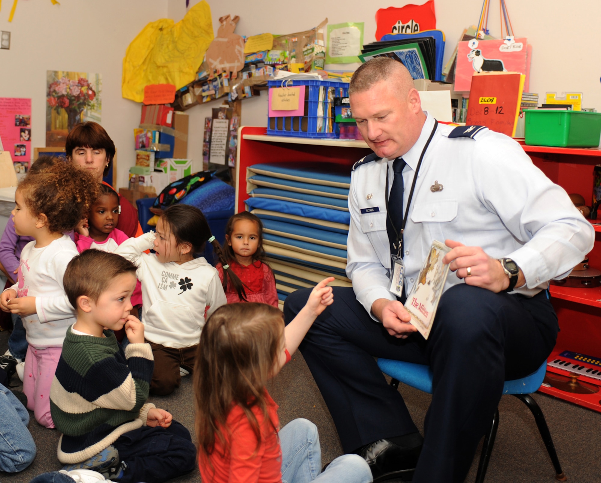 LANGLEY AIR FORCE BASE, Va. – Col. Kevin Altman, 1st Mission Support Group commander reads “The Mitten” to children at the child development center Dec 8. The book club gives  community volunteers and the mayor an opportunity to visit preschool classrooms each month to promote a healthy habit and affection for reading.  (U.S. Air Force photo/Airman 1st Class Gul Crockett)