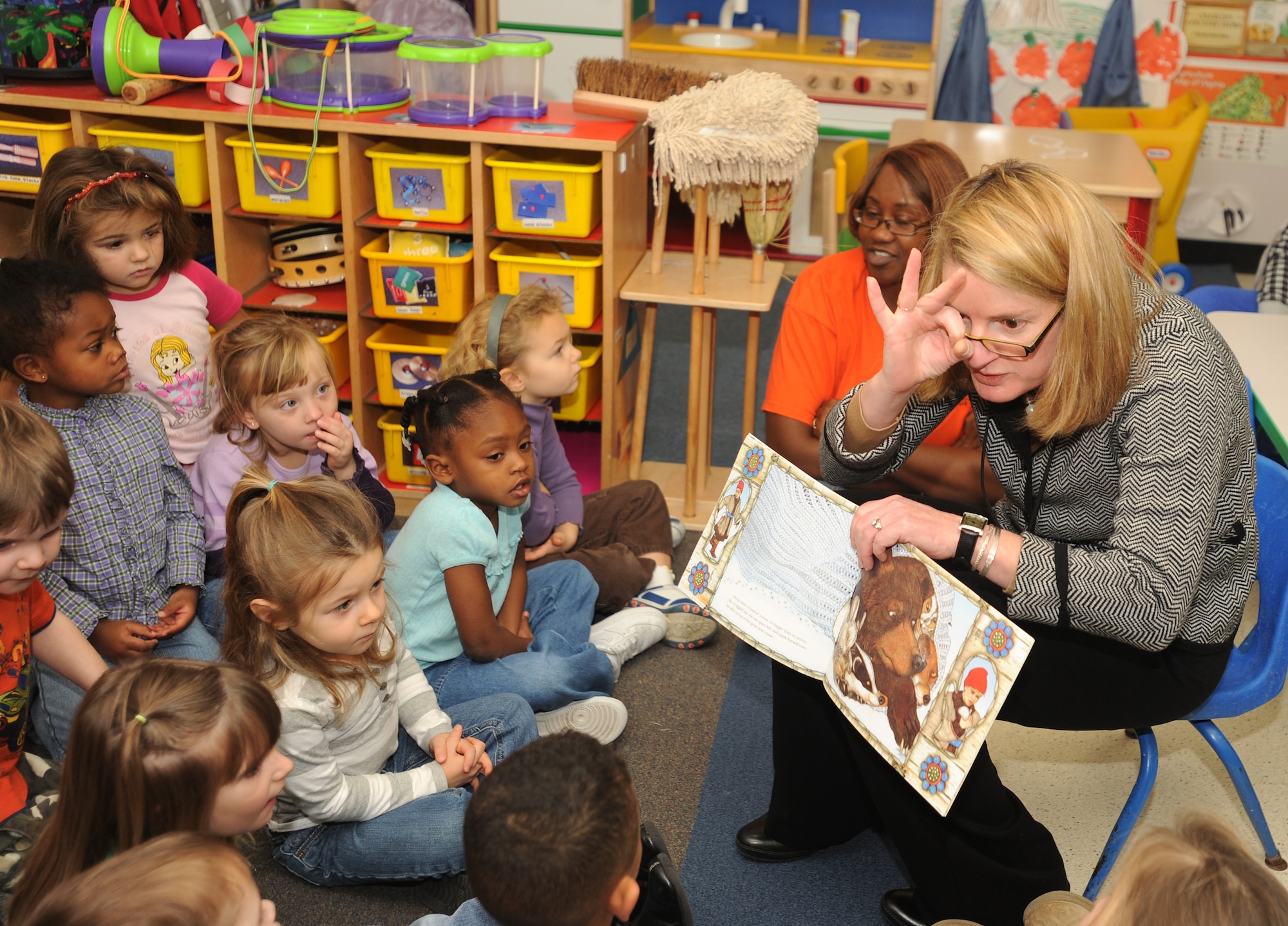 LANGLEY AIR FORCE BASE, Va. -- City of Hampton's Mayor Molly Ward reads “The Mitten” to children at the child development center as part of the Mayor's Book Club Dec. 8. The book club gives community volunteers and the mayor an opportunity to visit preschool classrooms each month to promote a healthy habit and affection for reading.  (U.S. Air Force photo/Airman 1st Class Gul Crockett)