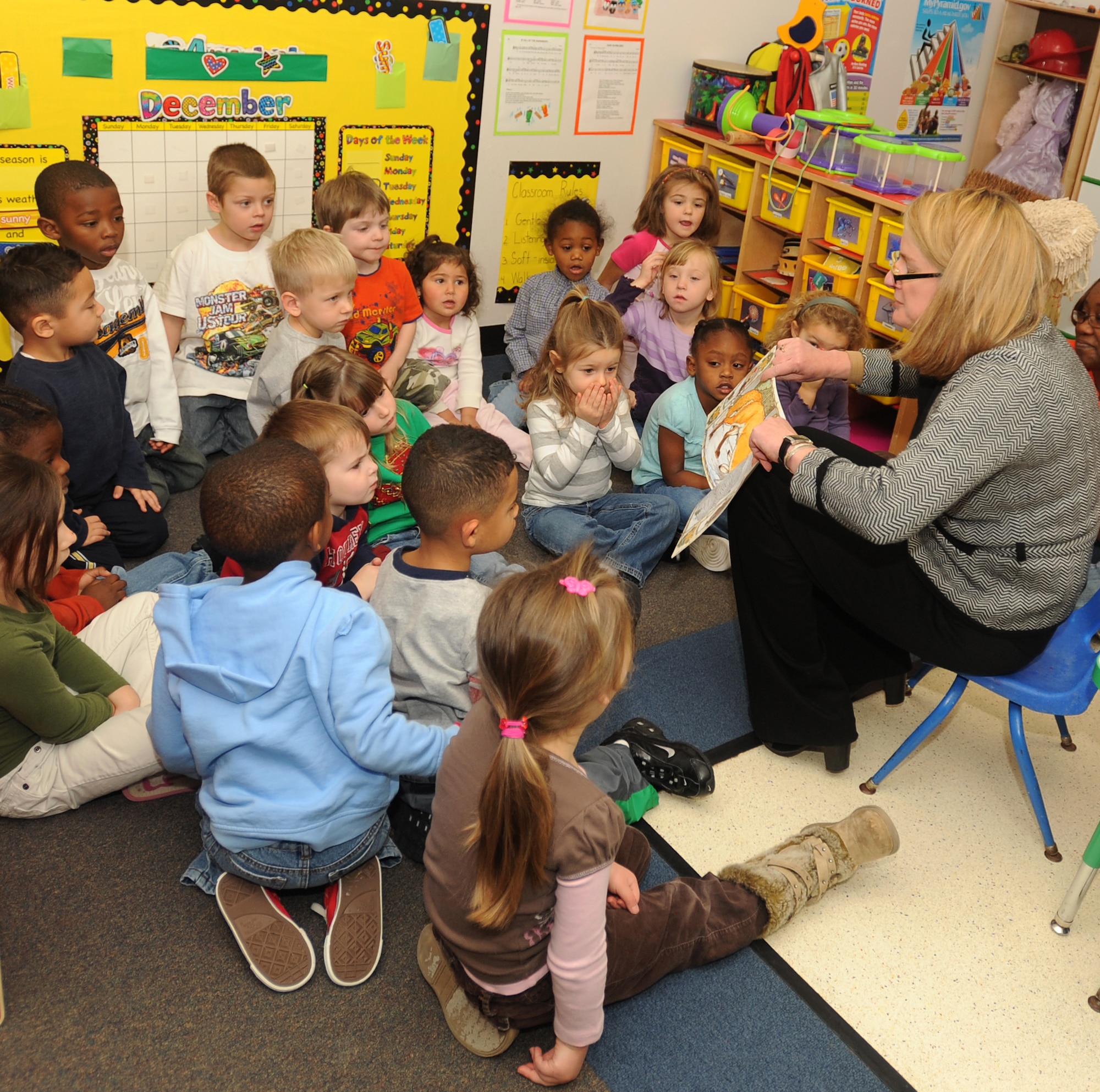 LANGLEY AIR FORCE BASE, Va. -- City of Hampton's Mayor Molly Ward reads “The Mitten” to children at the child development center as part of the Mayor's Book Club Dec. 8. The book club gives community volunteers and the mayor an opportunity to visit preschool classrooms each month to promote a healthy habit and affection for reading.   (U.S. Air Force photo/Airman 1st Class Gul Crockett)