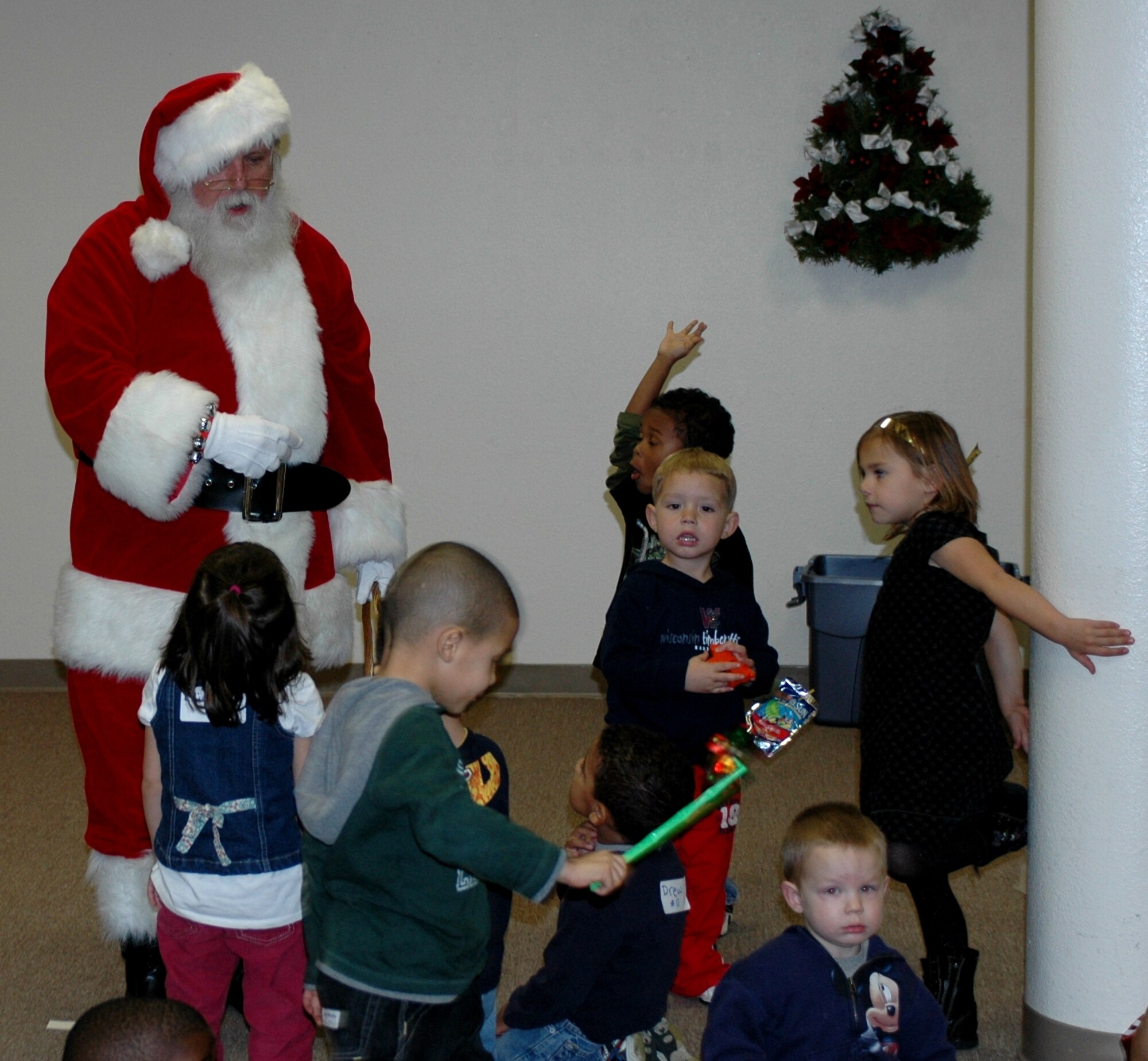 Children at Teddy Child Watch get a visit from Santa during the Deployed Spouses Dinner Dec. 8 at the Travis Conference Center. The event gave the spouses and children of those deployed a chance to socialize with other families, hear from base leadership and learn about a variety resources to assist them while their spouse is deployed. (U.S. Air Force photo/Airman 1st Class Kristen Rohrer)