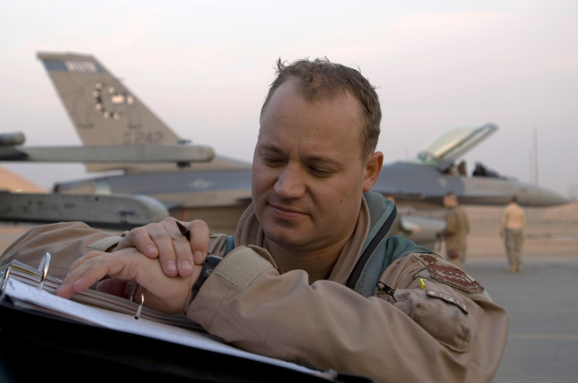 Maj. Curt Grayson fills out paperwork shortly after landing at Joint Base Balad, Iraq, Dec. 10. Grayson's home unit, the Minnesota Air National Guard's 179th Fighter Squadron, will carry the 332nd Expeditionary Fighter Squadron designation while deployed. Grayson, an F-16 Fighting Falcon pilot, is a native of Esco, Minn. (U.S. Air Force photo/Tech. Sgt. Erik Gudmundson)