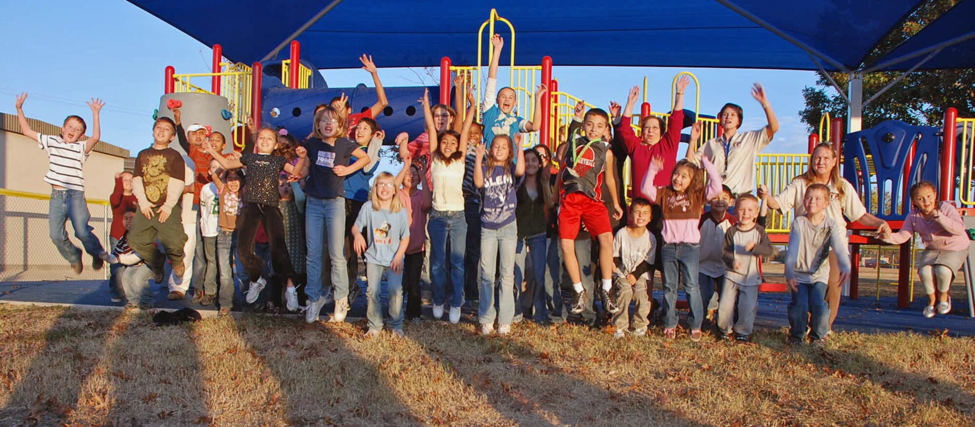 LAUGHLIN AIR FORCE BASE, Texas –Children from the Youth Center here show how excited they are about the new playground set for the Youth Center here Dec. 8. “The new playground has been long awaited,” said Kristin Tighe, Youth Center director. “The old playground was very outdated, but this one has all new equipment including rock and wall climbing. It’s a playground geared toward physical fitness and older children.” (U.S. Air Force photo by Airman 1st Class Sara Csurilla)