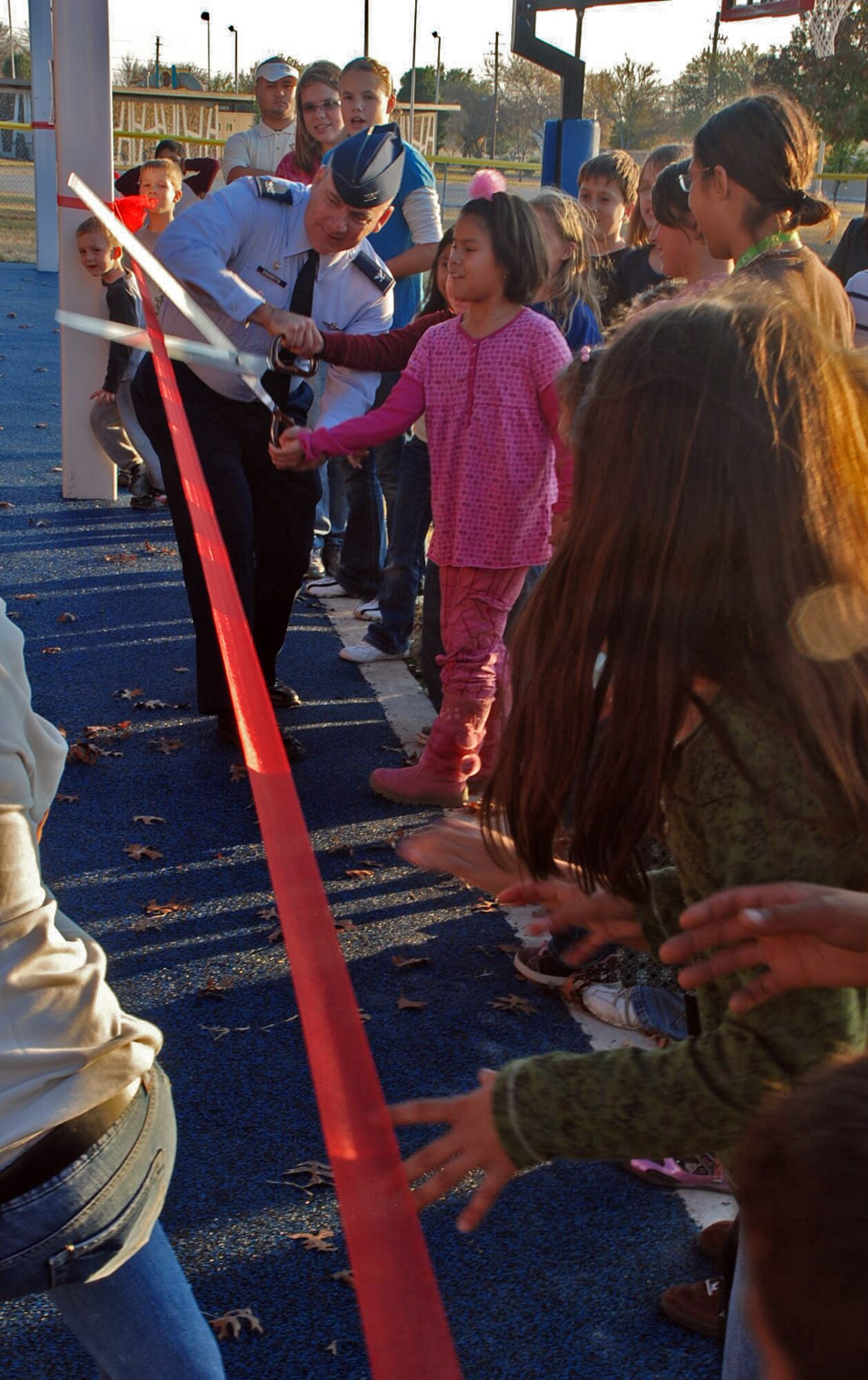 LAUGHLIN AIR FORCE BASE, Texas –Children from the Youth Center here play on the rock climbing part of the  new playground set here for the Youth Center Dec. 8. “The new playground has been long awaited,” said Kristin Tighe, Youth Center director. “The old playground was very outdated, but this one has all new equipment including rock and wall climbing. It’s a playground geared toward physical fitness and older children.” (U.S. Air Force photo by Airman 1st Class Sara Csurilla)