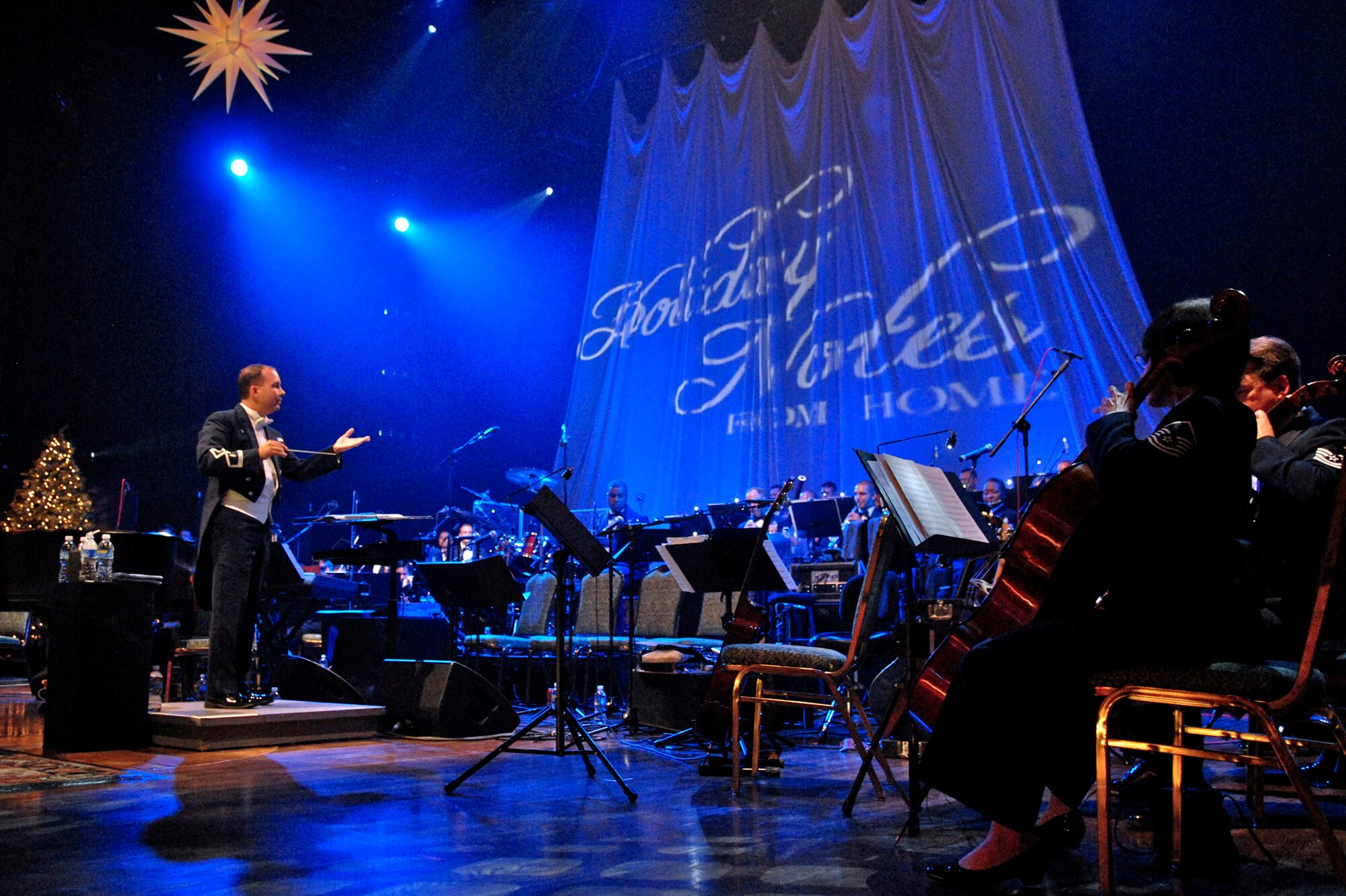 Major Don Schofield leads more than 60 musicians from the Band of the Air Force Reserve and Air Force Strings during the 2008 Holiday Notes from Home concert recorded Dec. 9 in Nashville, Tenn. The concert is an annual holiday event recorded at the Grand Ole Opry House as a tribute to military men and women serving around the world. The show airs on Great American Country and on American Forces Network channels throughout December. Major Schofield is the Band of the Air Force Reserve commander. (U.S. Air Force photo/Ken Hackman) 
