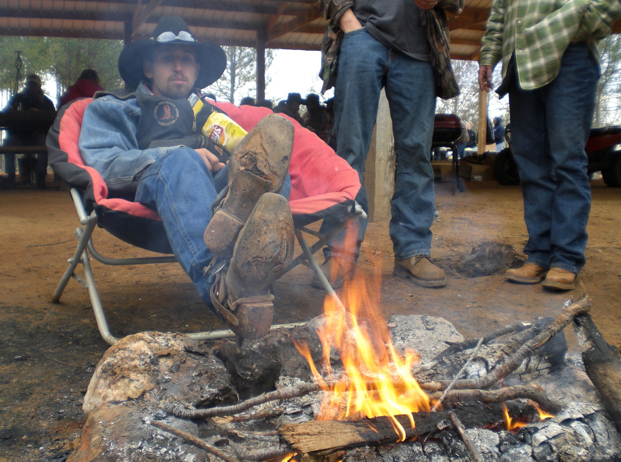 SHAW AIR FORCE BASE, S.C. -- Jared Dillon, one of the horseback rider group leaders in Hoofin? for Heroes, stops for a bite to eat lunch and warm his feet Saturday, Dec. 7 before heading back out on the trail at Double J Ranch in Whitmire, S.C.  Proceeds from Hoofin? for Heroes go directly to the Wound Warrior Project, a nonprofit organization that seeks to assist men and women of the U.S. armed forces who have been severely injured in conflicts overseas. (U.S. Air Force photo/2nd Lt. Noelle Caldwell)