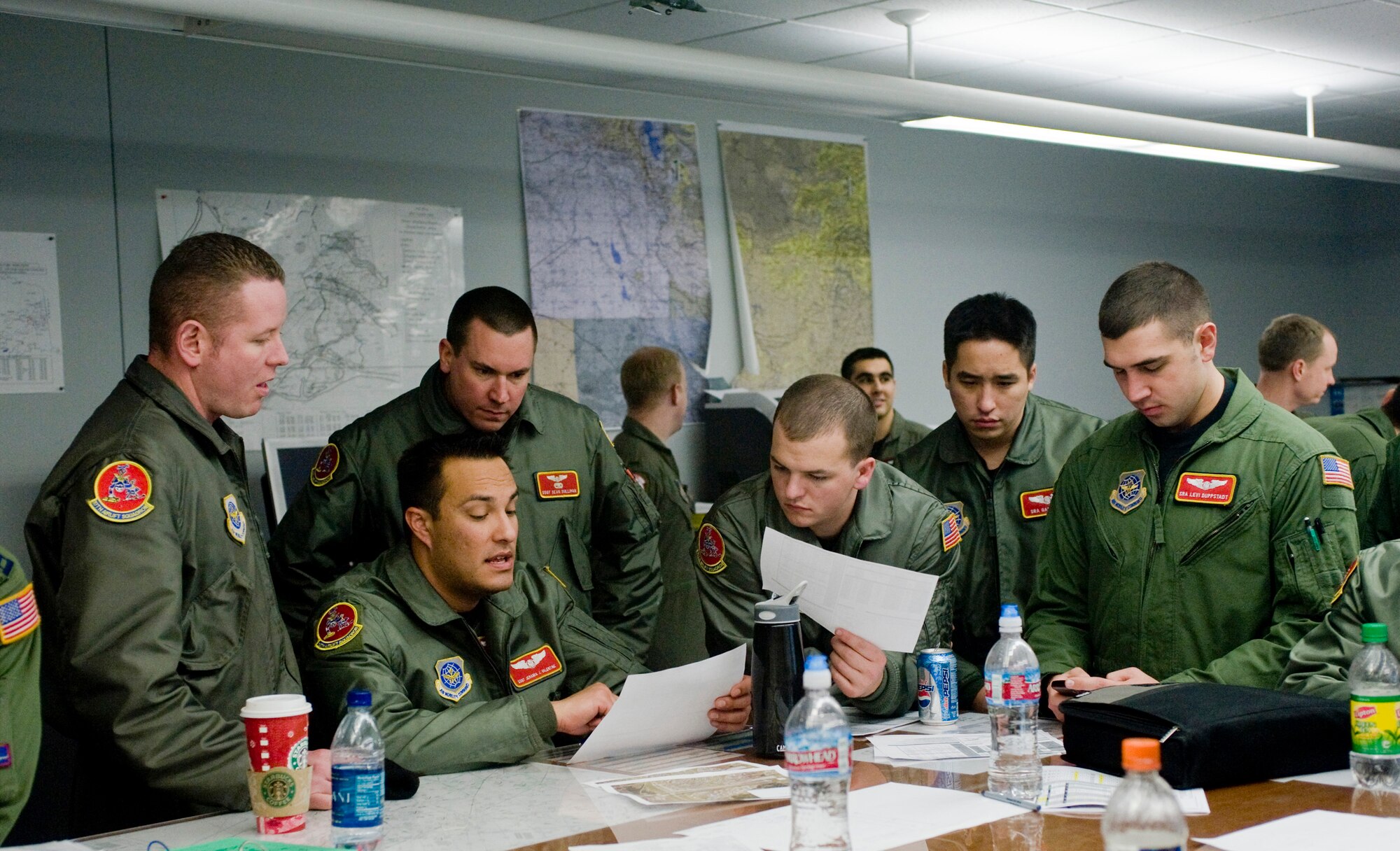 ELMENDORF AIR FORCE BASE, Alaska -- Aircrew from 10th Airlift Squadron plan out flight plan for a six C-17 flight formation and air drop with 517th Airlift Squadron   Dec. 9. The 4th Brigade Combat Team, 25th Infantry Division partnered with the 517th Airlift Squadron is using this week practice jumps prior to the deployment. Roughly 1,300 4-25 Soldiers will be jumping out of C-17 Globemaster IIIs during the week. (U.S. Air Force photo/Senior Airman Jonathan Steffen)