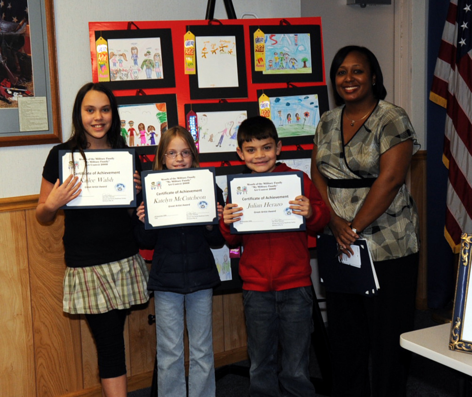 “My Military Family” Art Contest winners pose after the awards ceremony at McGuire’s Airman and Family Readiness Center Dec. 9. In honor of Month of the Military Family in November, children submitted artwork to represent their military families; children placed according to their age category. (U.S. Air Force photo/2nd Lt. Christine Darius)