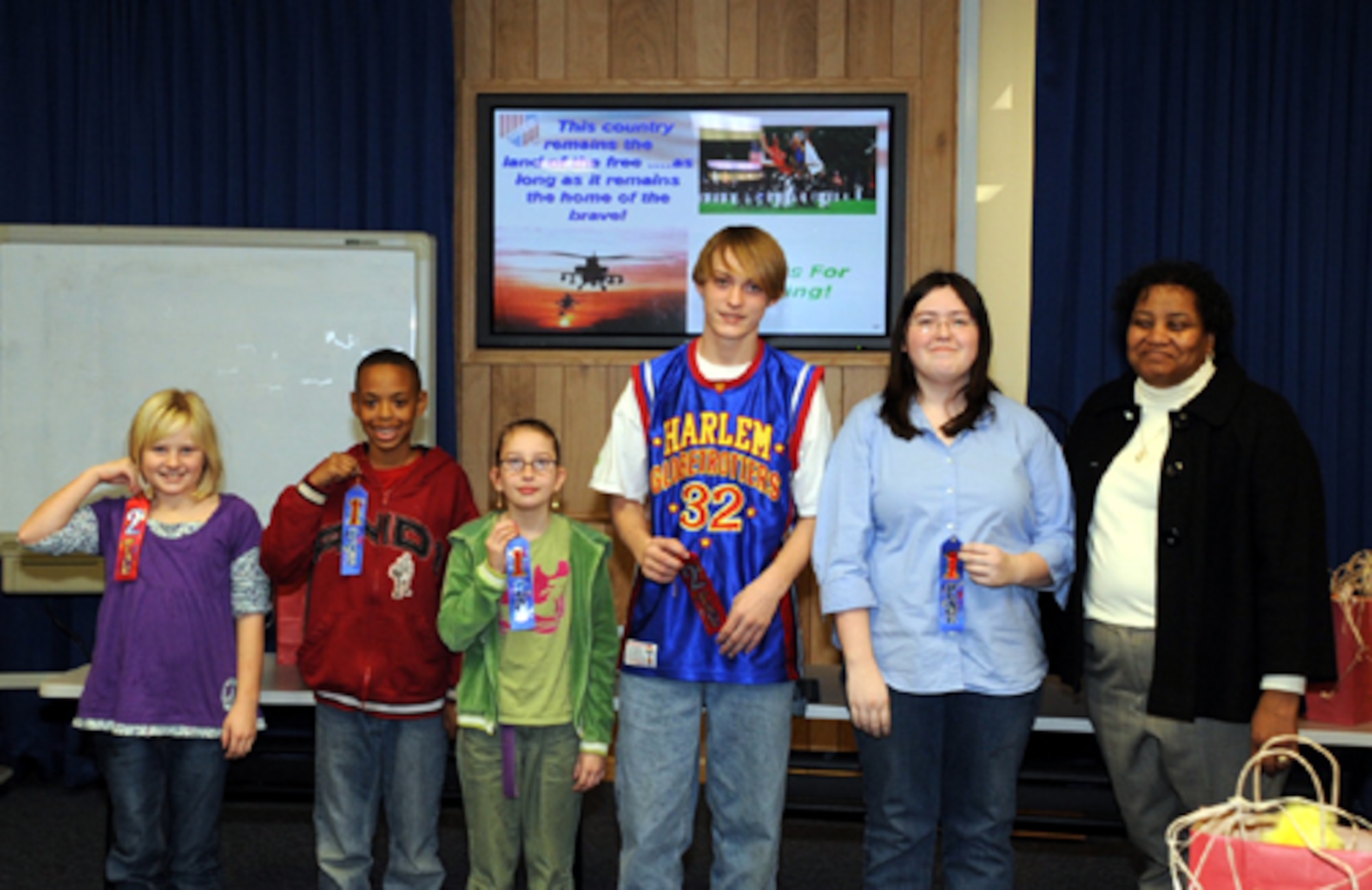 “My Military Family” Art Contest essay winners pose after the awards ceremony at McGuire’s Airman and Family Readiness Center Dec. 9. Children, ages 7 and up, submitted essays about their military families in honor of Month of the Military Family in November. 