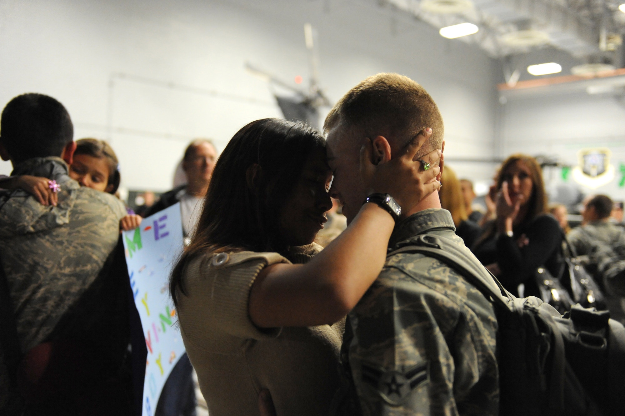 Airman 1st Class Daniel Rodgers embraces his wife, Airman 1st Class Stephanie Rubi, Dec. 6 at Nellis Air Force Base, Nev. Airmen with the 763rd Maintenance Squadron and 66th Rescue Squadron returned home after 3.5 months in Southwest Asia supporting the war on terrorism. He is an HH-60 avionics specialist assigned to the 763rd MXS and she is a still photographic apprentice assigned to the 99th Air Base Wing  (U.S. Air Force photo/Senior Airman Larry E. Reid Jr.)
