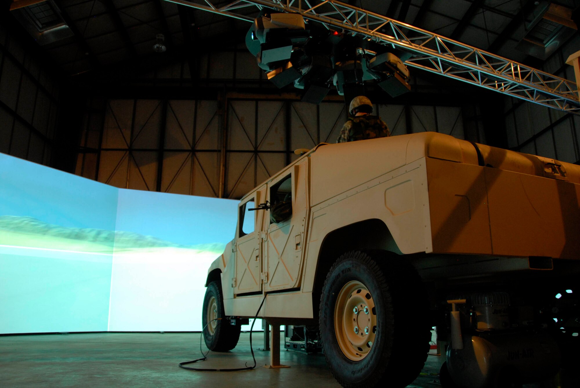 A 280-degree screen brings to life real-world scenarios designed to put a four-person fire team made up of a driver, gunner, rifleman and troop commander through the paces of an actual convoy mission in October at Volk Field, Wis. (U.S. Air Force photo/Master Sgt. Dan Richardson) 
