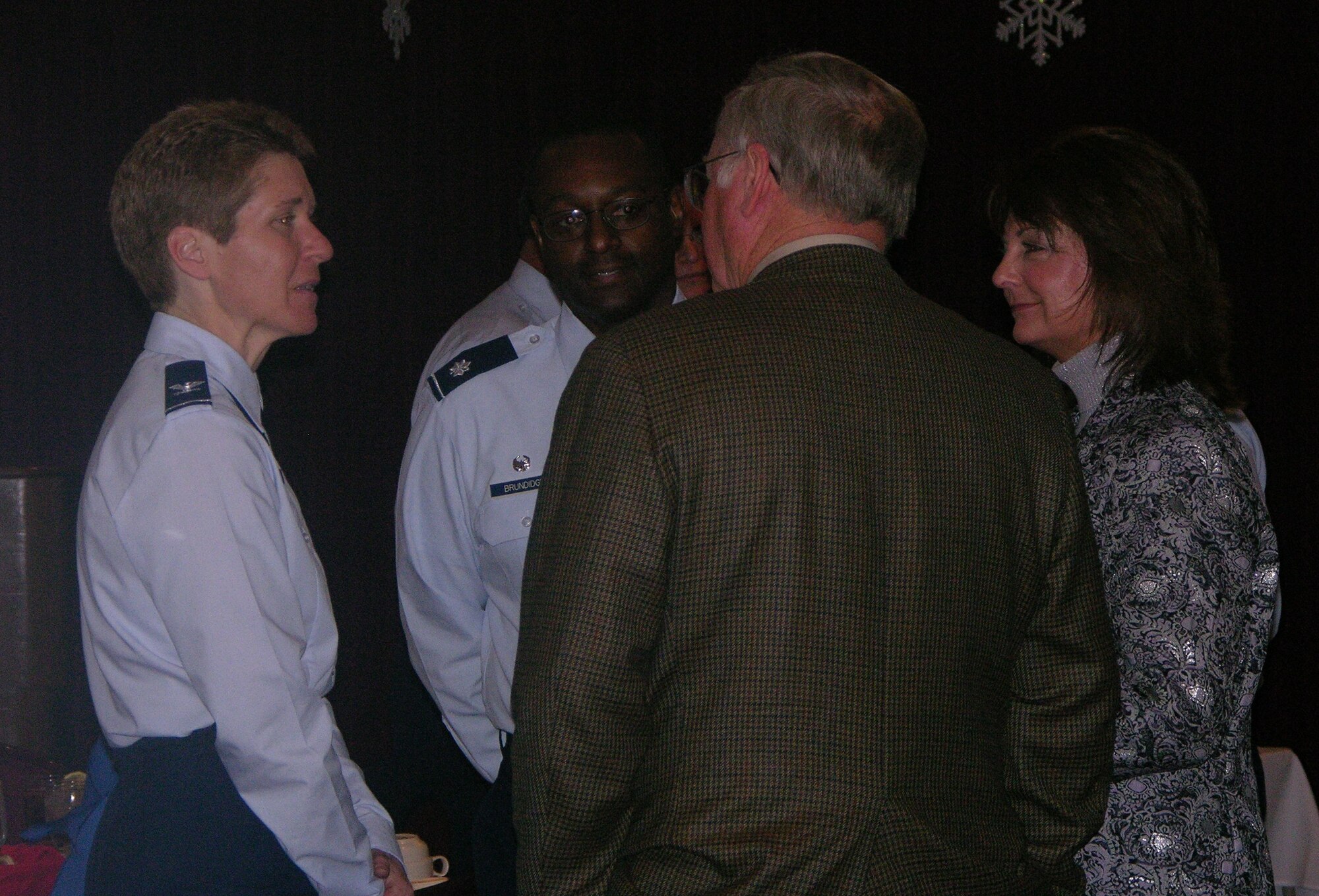 Col. Pat Hoffman, commander, 552 ACW, and Lieutenant Col. Lawrence Brundidge, commander, 960th Airborne Air Control Squadron, talk with the Honorary Commanders as they arrive to the quarterly luncheon December 8. Photo courtesy of Tech. Sgt Rachel Moore.