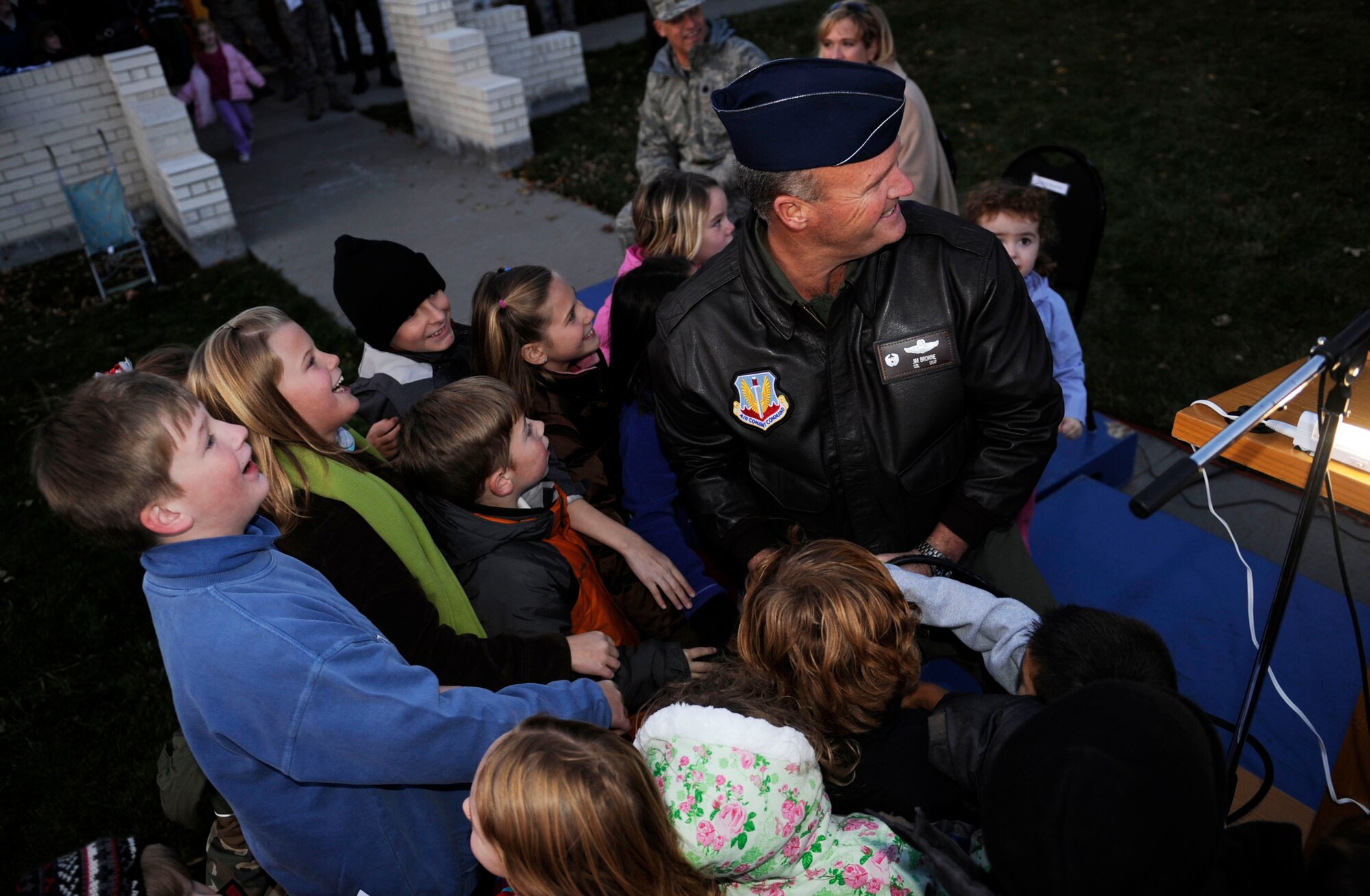 MOUNTAIN HOME AIR FORCE BASE, Idaho – Col. James Browne, 366th Fighter Wing commander, invites children to help him pull the switch to light the chapel Christmas tree during the tree lighting ceremony Dec. 3. The First Sergeants Association and base chapel teamed up to bring holiday cheer with a holiday parade followed by a Christmas tree lighting ceremony. After the ceremony, hot chocolate, hot apple cider, cookies and pictures with Santa Claus were available in the chapel. (U.S. Air Force photo/Airman 1st Class Ryan Crane)