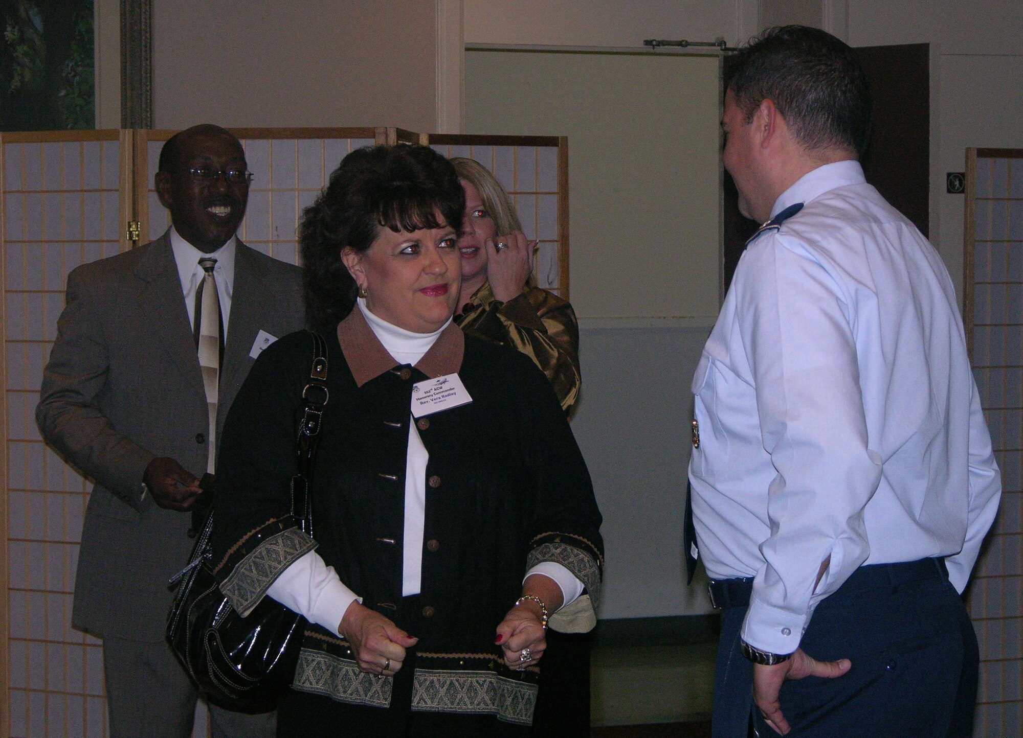 Lieutenant Col. Richard Folks, 552 ACG, talks with Reverand Vera Radley, pastor, Del City First Church of the Nazarene, at the quarterly Honorary Commanders Luncheon December 8. Photo courtesy of Tech. Sgt. Rachel Moore.